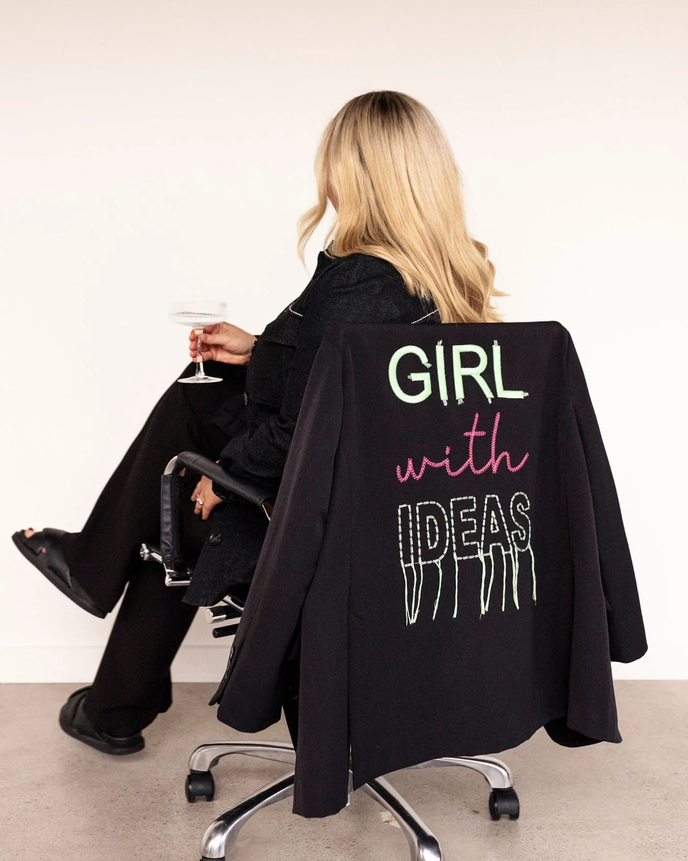 I found this blazer in Italy. Clean cut. Classic black. Then I clocked the words embroidered across the back in hot pink:
&ldquo;Girl with ideas.&rdquo;

I nearly tripped over a display table getting to the counter.

It was a full-body yes. I&rsquo;v