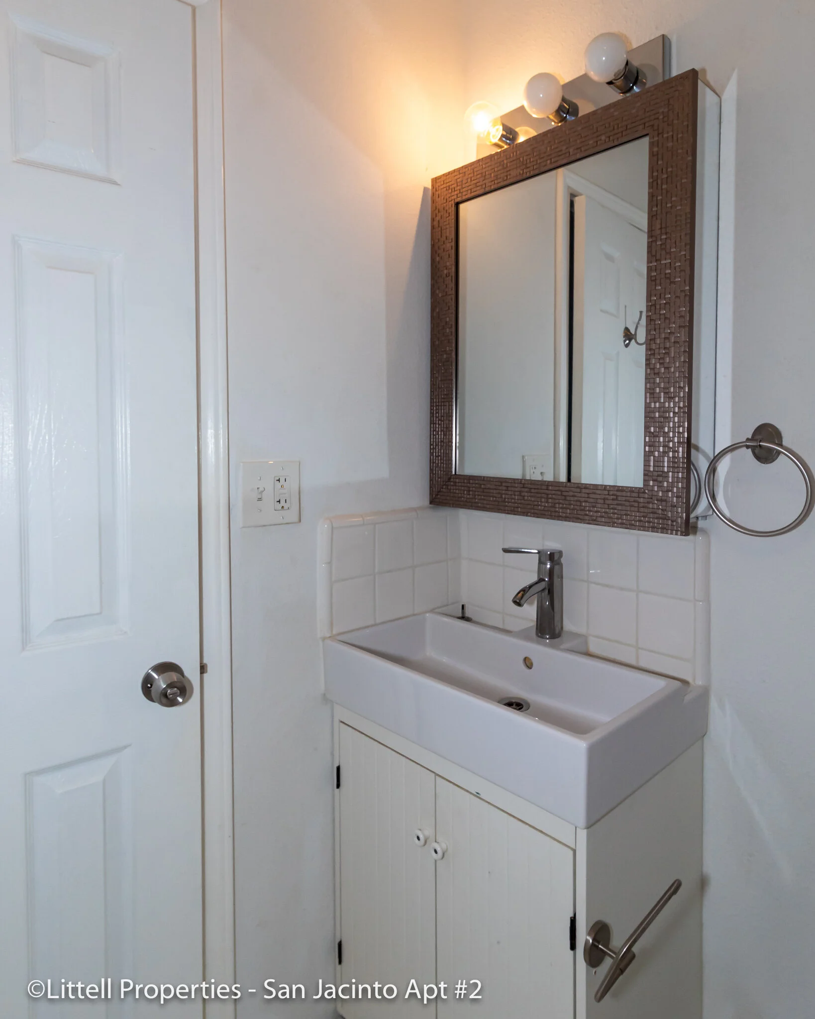 Bathroom vanity and mirror above