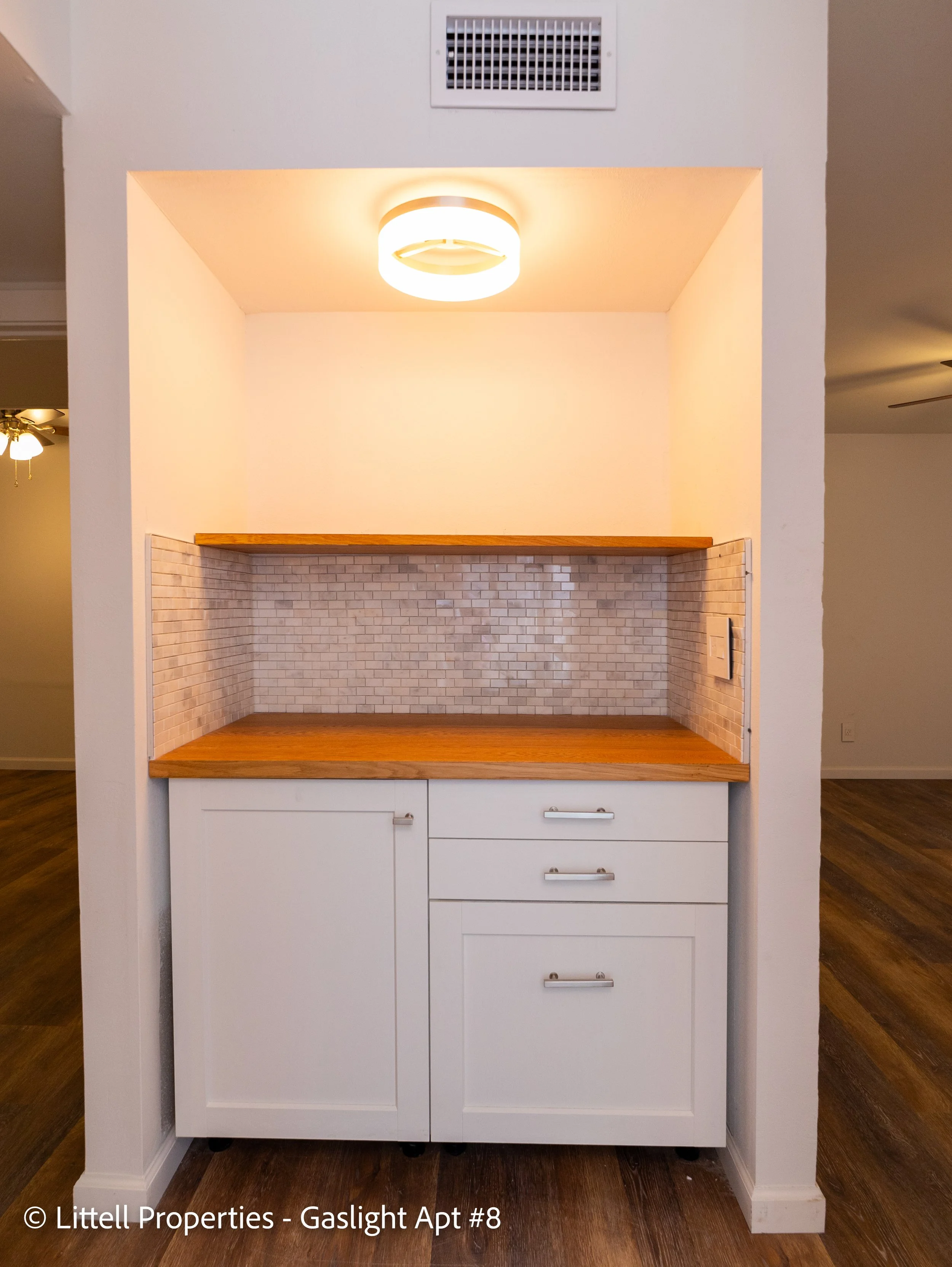  This larger custom built kitchen nook is a perfect place for a coffee bar or a cocktail bar, or both!  