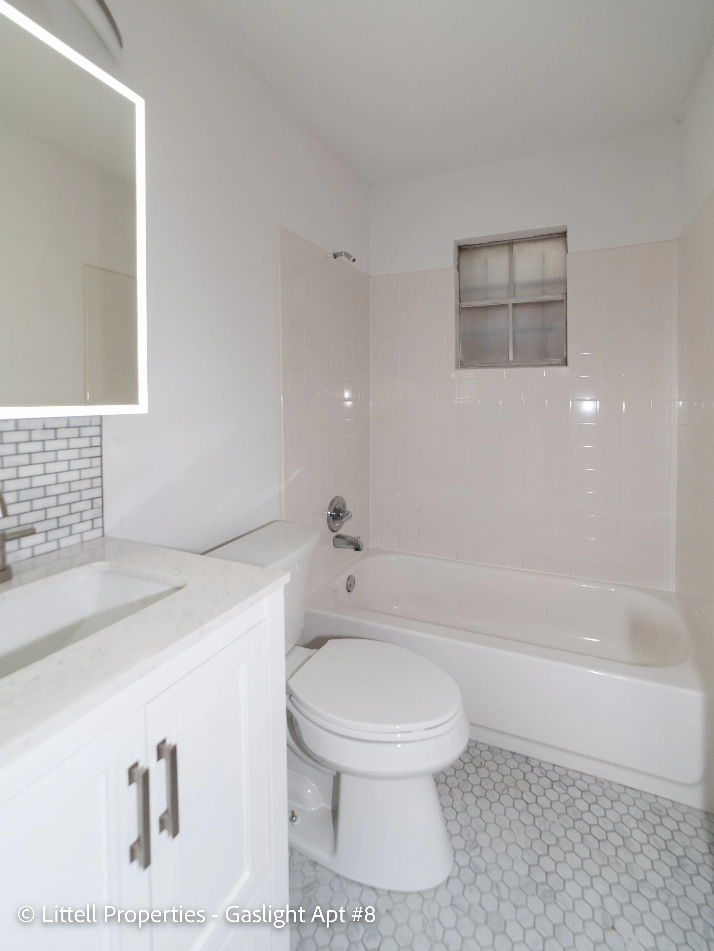  The bathroom has a brand new vanity and a medicine cabinet. The medicine cabinet mirror lights up around the border!  