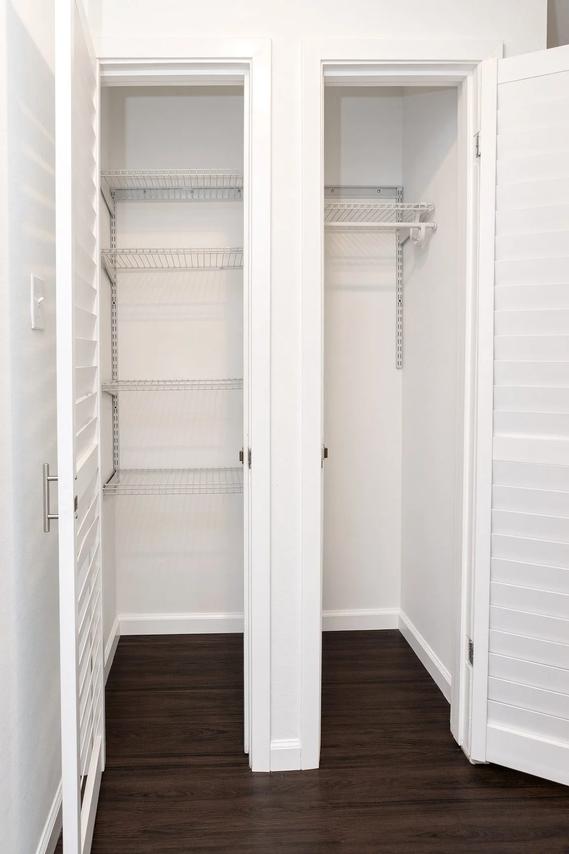  2 storage closets in the hallway with built in Rubbermaid shelving  
