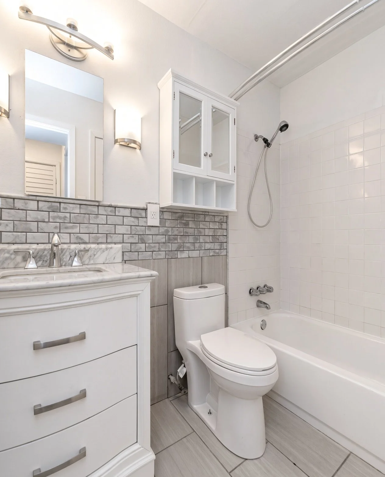  View of the bathroom with full bathtub/shower.  