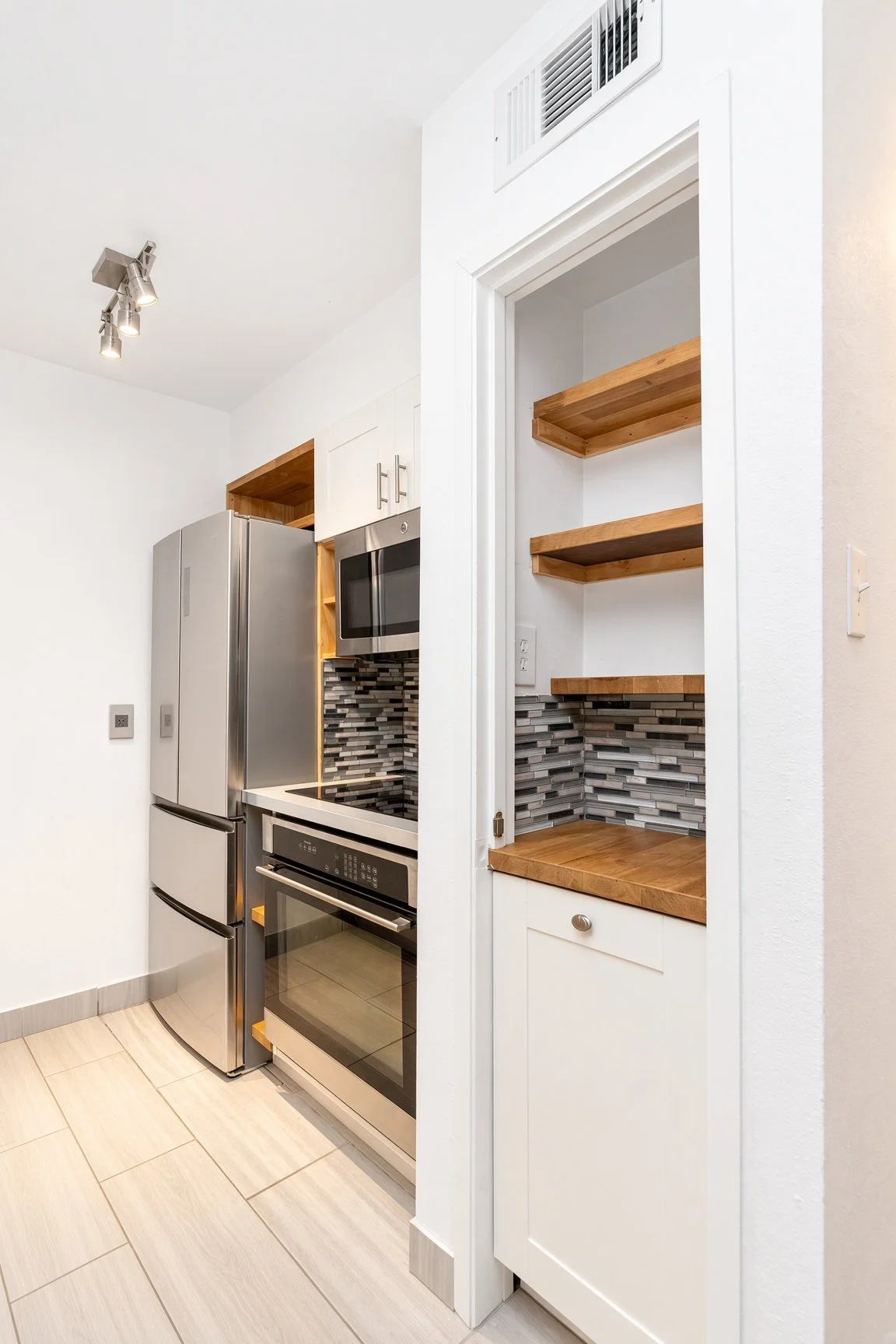  Built in pantry storage with a large pull out cabinet for trash  