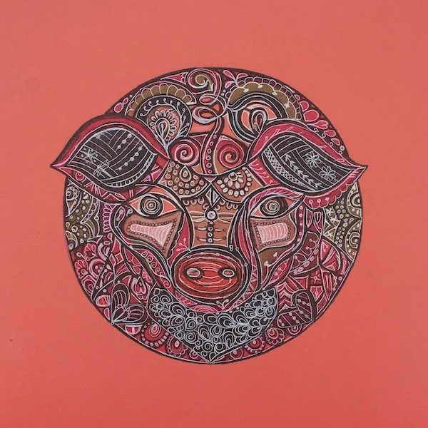 Colorful, intricate drawing of a cow's face made with abstract patterns and designs on a coral background.