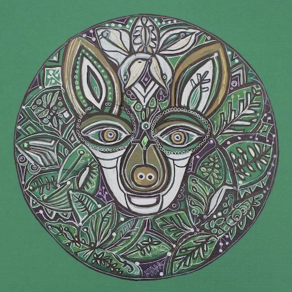 Circular artwork of a stylized animal face, possibly a monkey or ape, surrounded by leaves and floral patterns, featuring bold outlines and intricate details in green, purple, white, and tan colors.