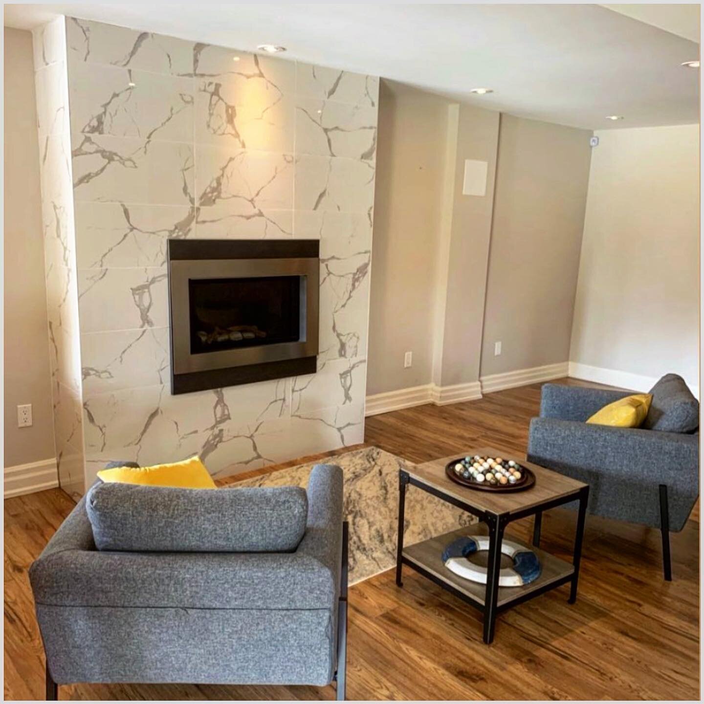 Custom Rec-room fireplace we did in Uxbridge. These are porcelain tiles with a &ldquo;marble&rdquo; pattern effect. When doing projects like this I lay the tiles out and customize just how I&rsquo;d like the pattern to look BEFORE I begin. Fellow Til