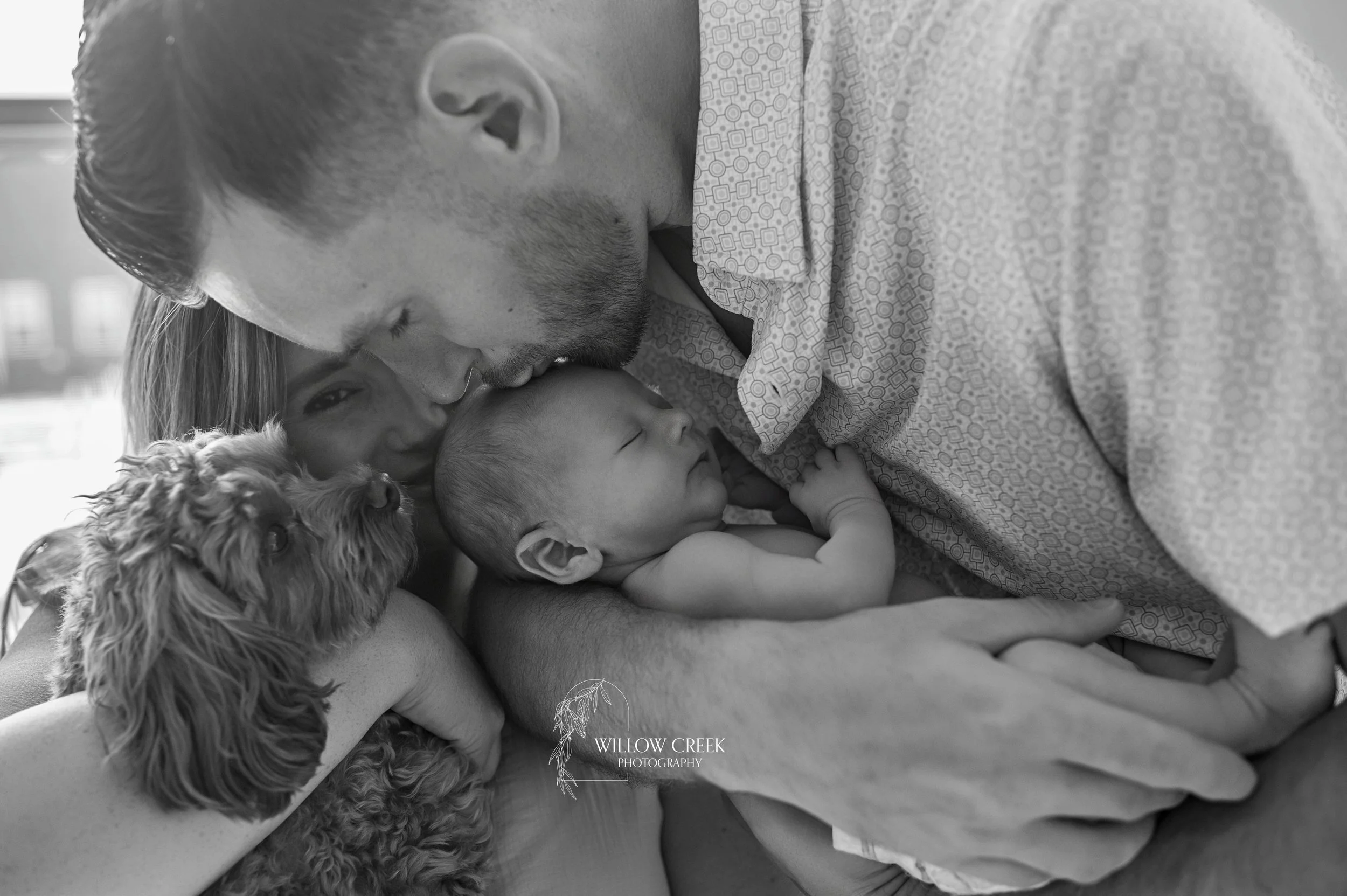 Newborn baby held by mama during an in-home session