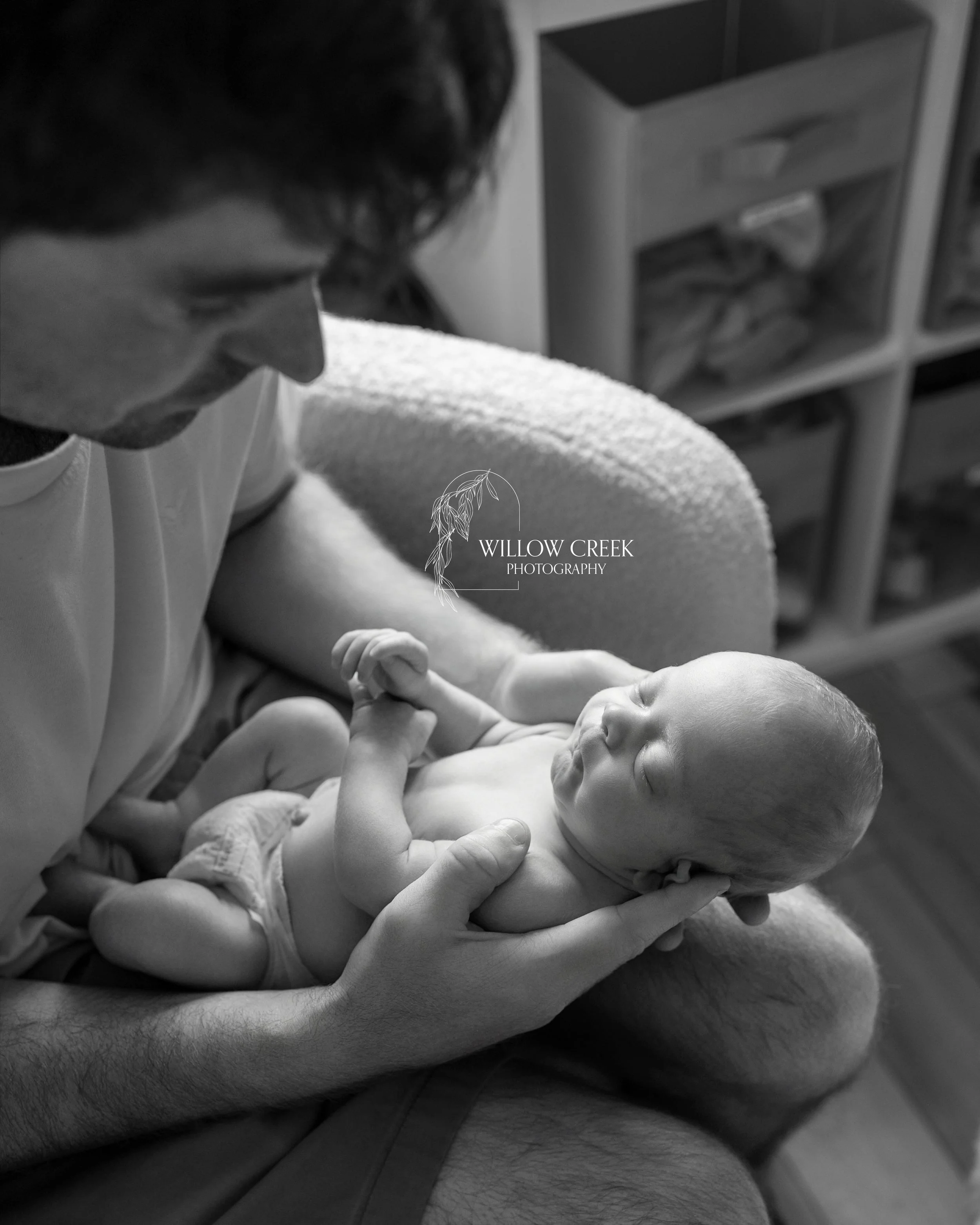 Dad holding baby in nursery, Wilmington NC
