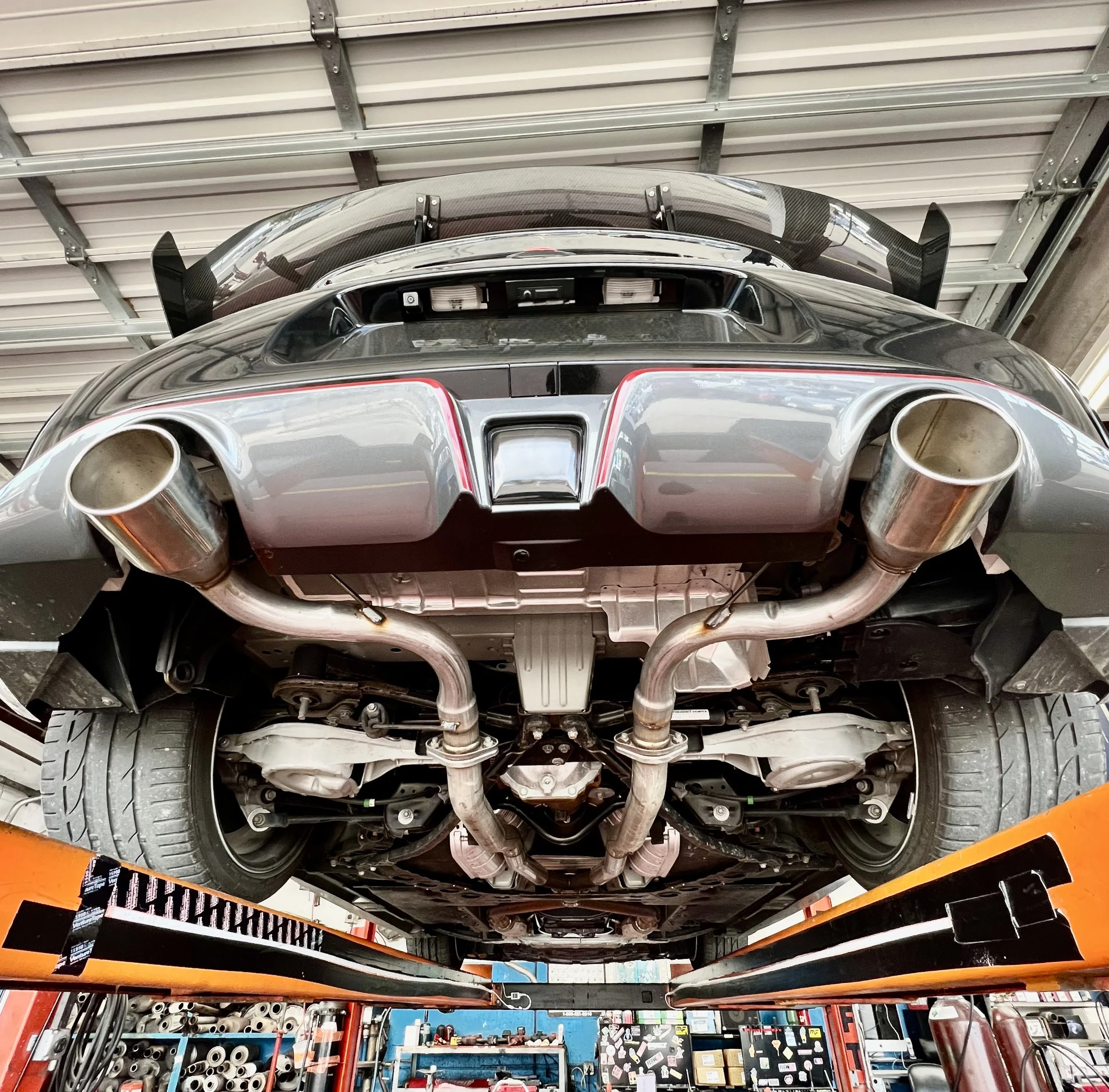 Image shows the car's exhaust pipes, where the exhaust was modified.  We did a muffler delete and installed exhaust tips at MGR Mufflers