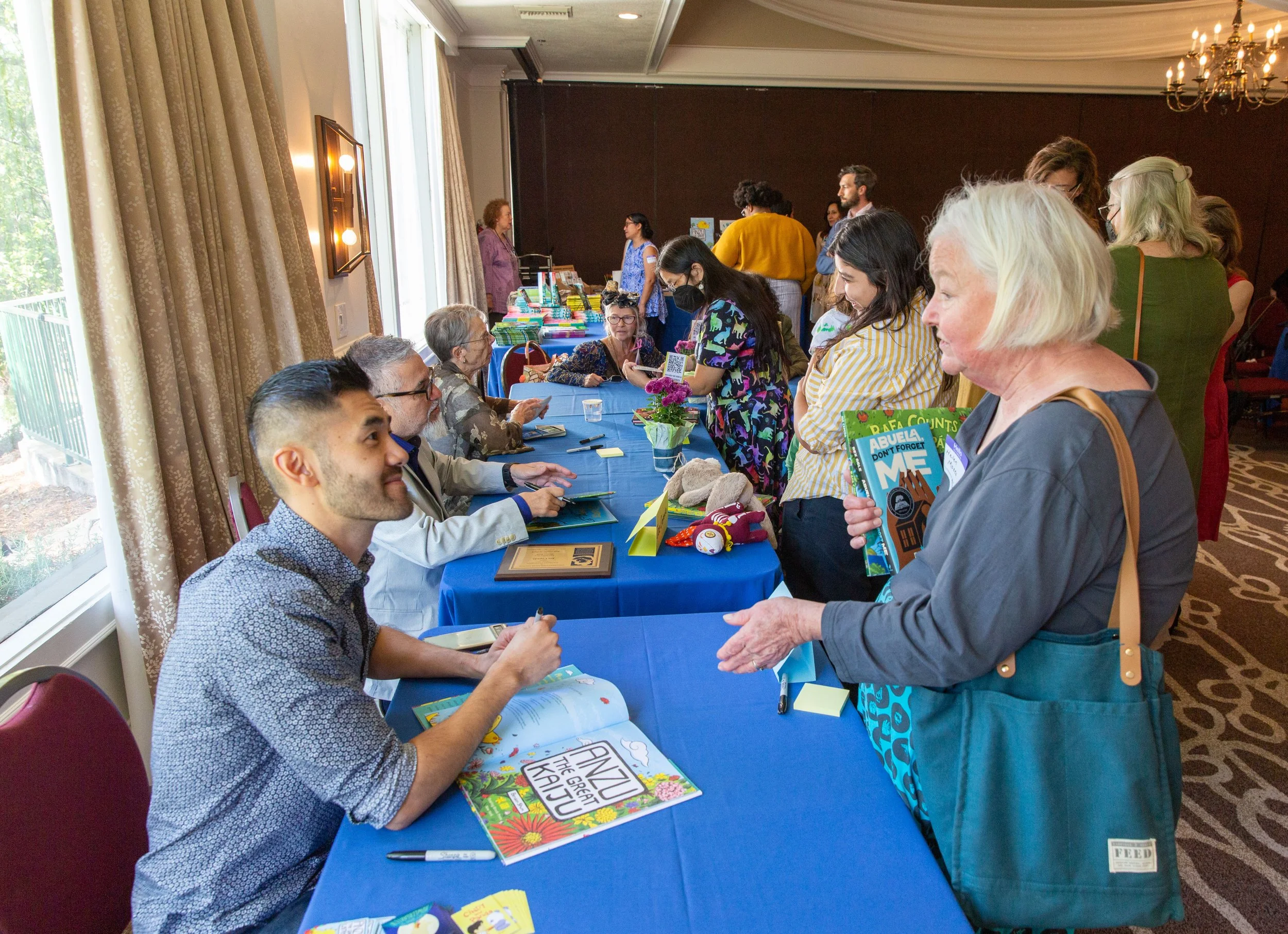 At the end of the signing table, author-illustrator Benson Shum chats with CLCSC Board Member Helen Moses. (Josh Steichmann)