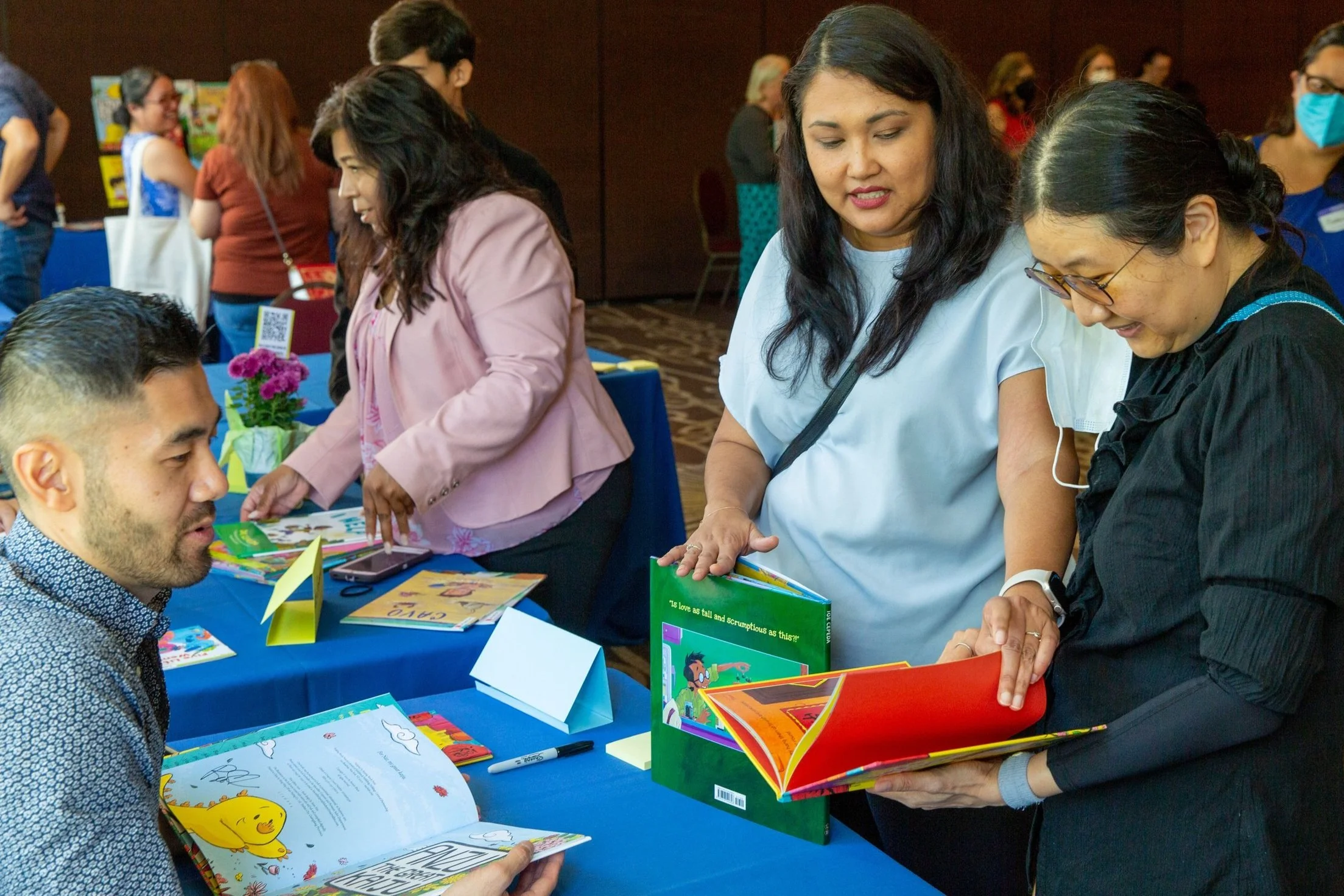 Author/illustrator Benson Shum chats with attendees at the signing table. (Josh Steichmann)