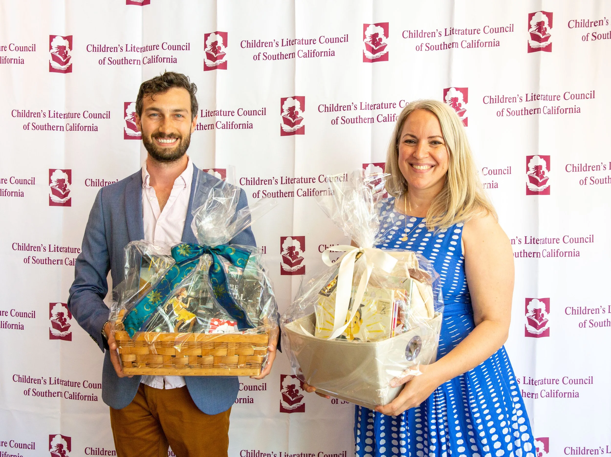 L to R: Kyle Horne helps silent auction winner Kadria Simons show off two picture book baskets. (Josh Steichmann)