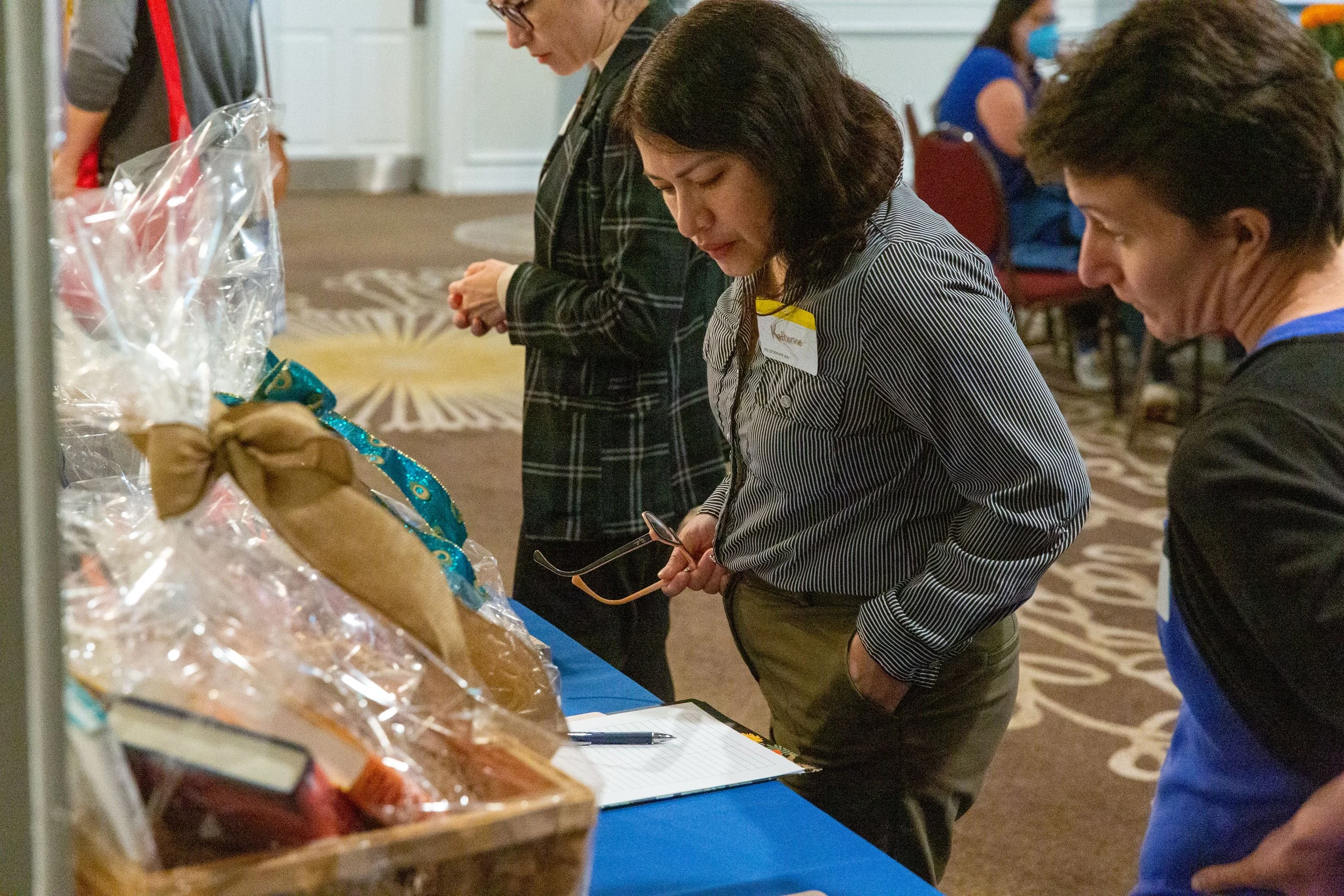 Guests at the 2023 CLCSC Awards Ceremony peruse the Silent Auction baskets and bidding sheets. (Josh Steichmann)