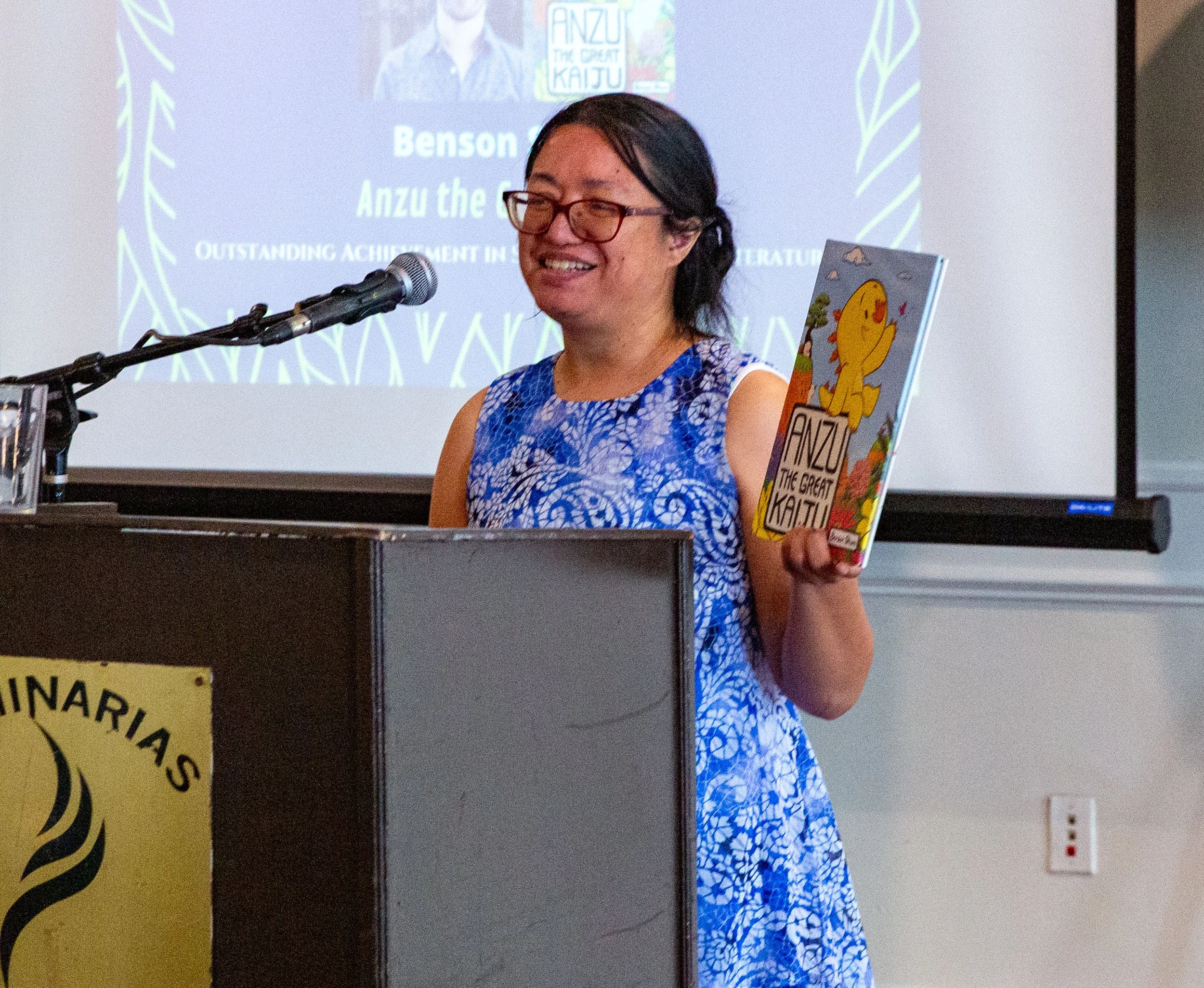 Awards Committee Member Helen Fairman presents winner Benson Shum and his book, Anzu the Great Kaiju. (Josh Steichmann)