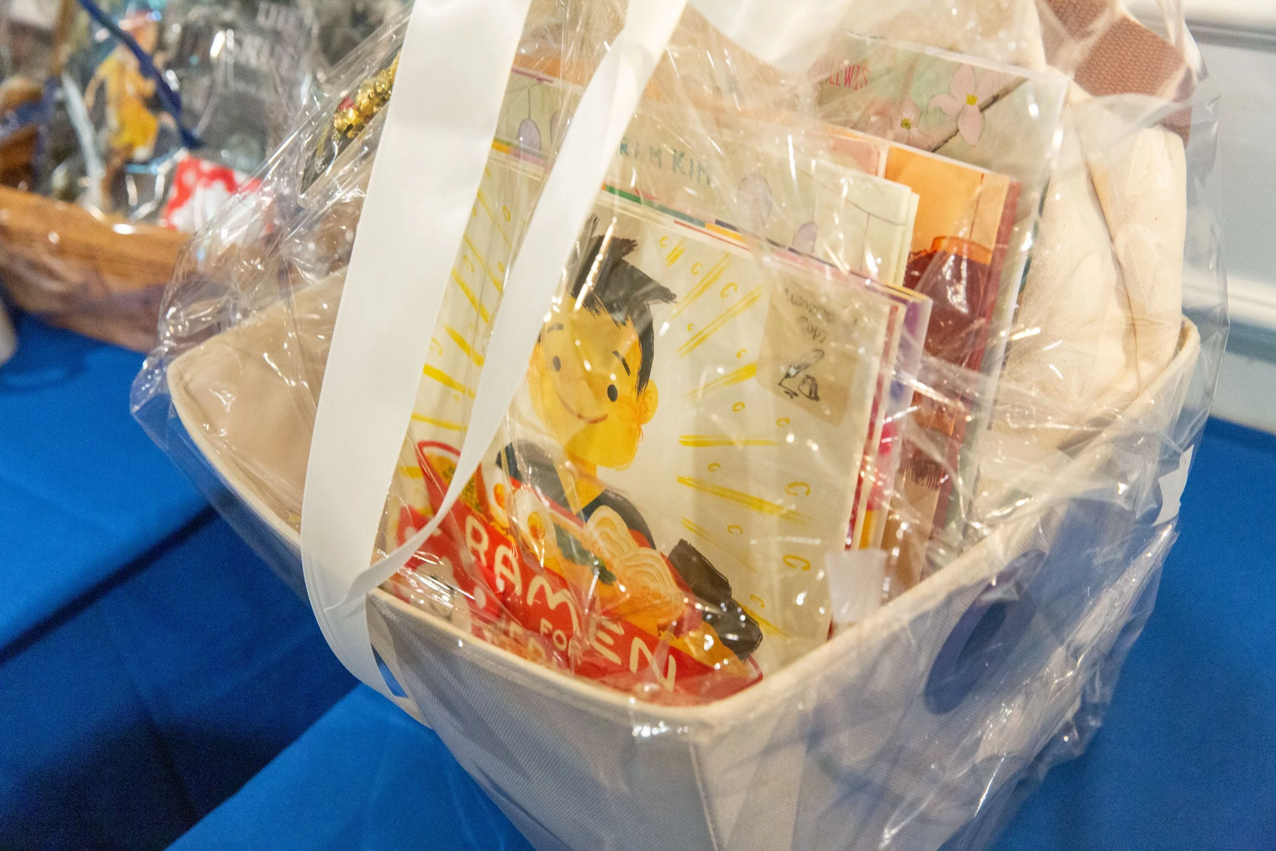 A food-themed picture book basket for the silent auction includes Ramen for Everyone, written by Patricia Tanumihardja and illustrated by Shiho Pate. (Josh Steichmann)