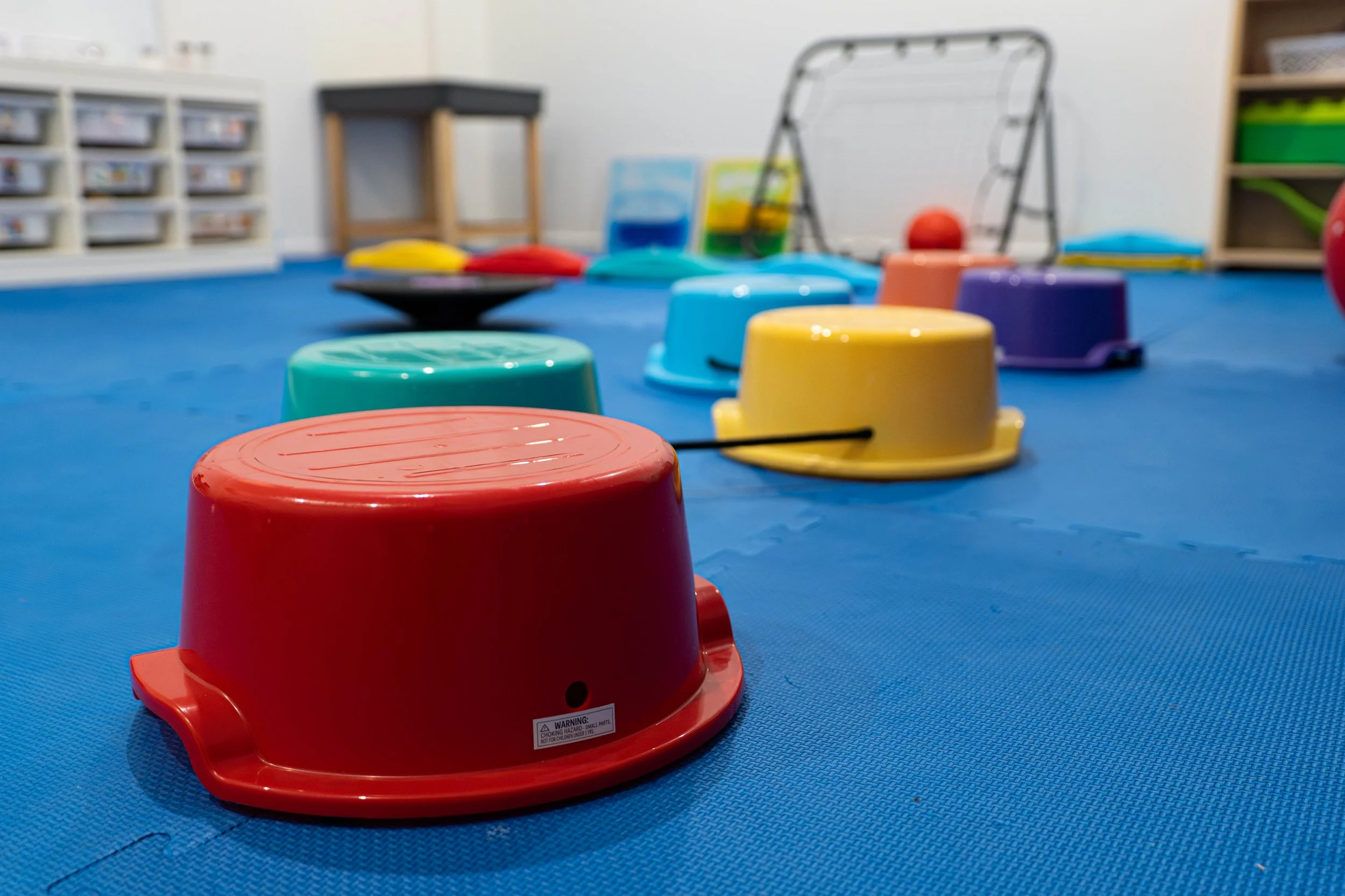 Coloured buckets turned upside to be used as seats for children.
