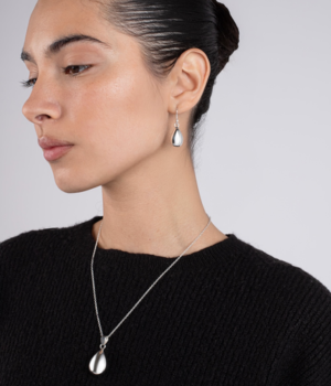 Model wearing Poloshed Silver Teardrop Pendant.png