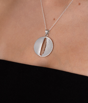 Model wearing Andea HammeredPolished Split Round Silver Pendant.png