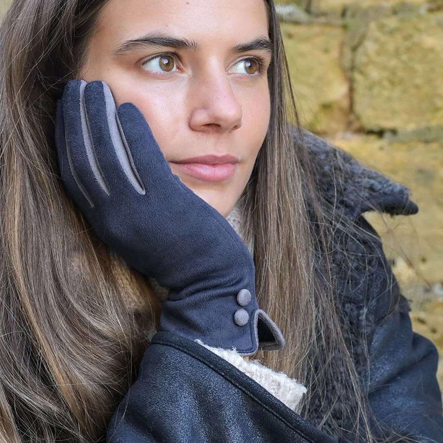 Model wearing contrast faux suede gloves with button detail. Navy and grey. Stylish yet practical