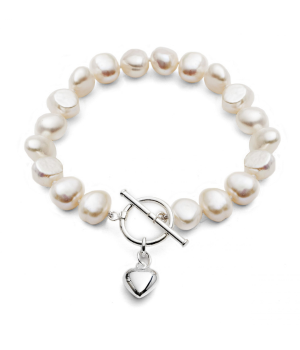 Single strand white freshwater pearl bracelet. Puffed silver heart charm.