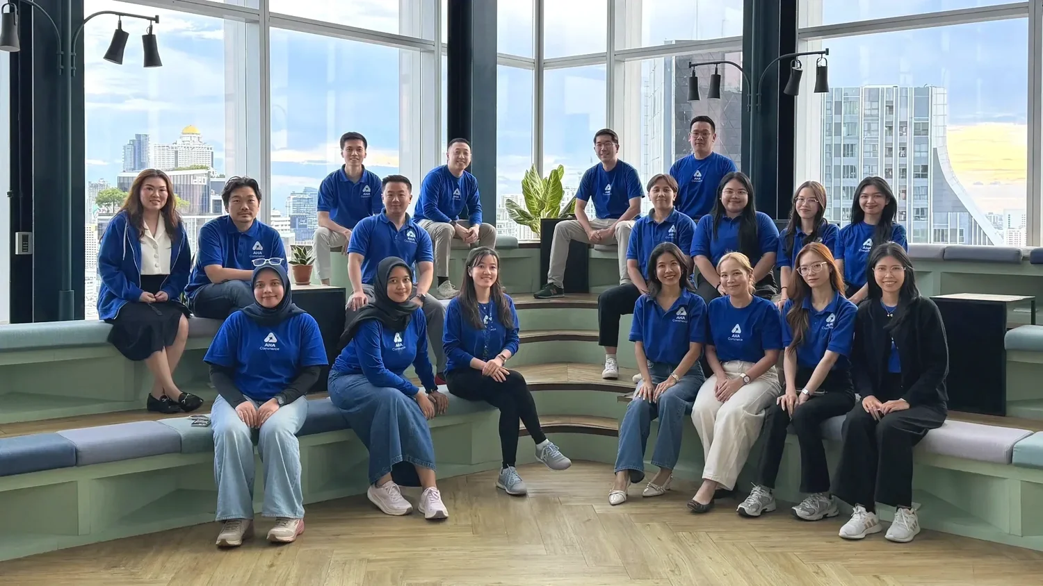 Tim AHA Commerce Thailand di kantor Bangkok dengan latar gedung kota