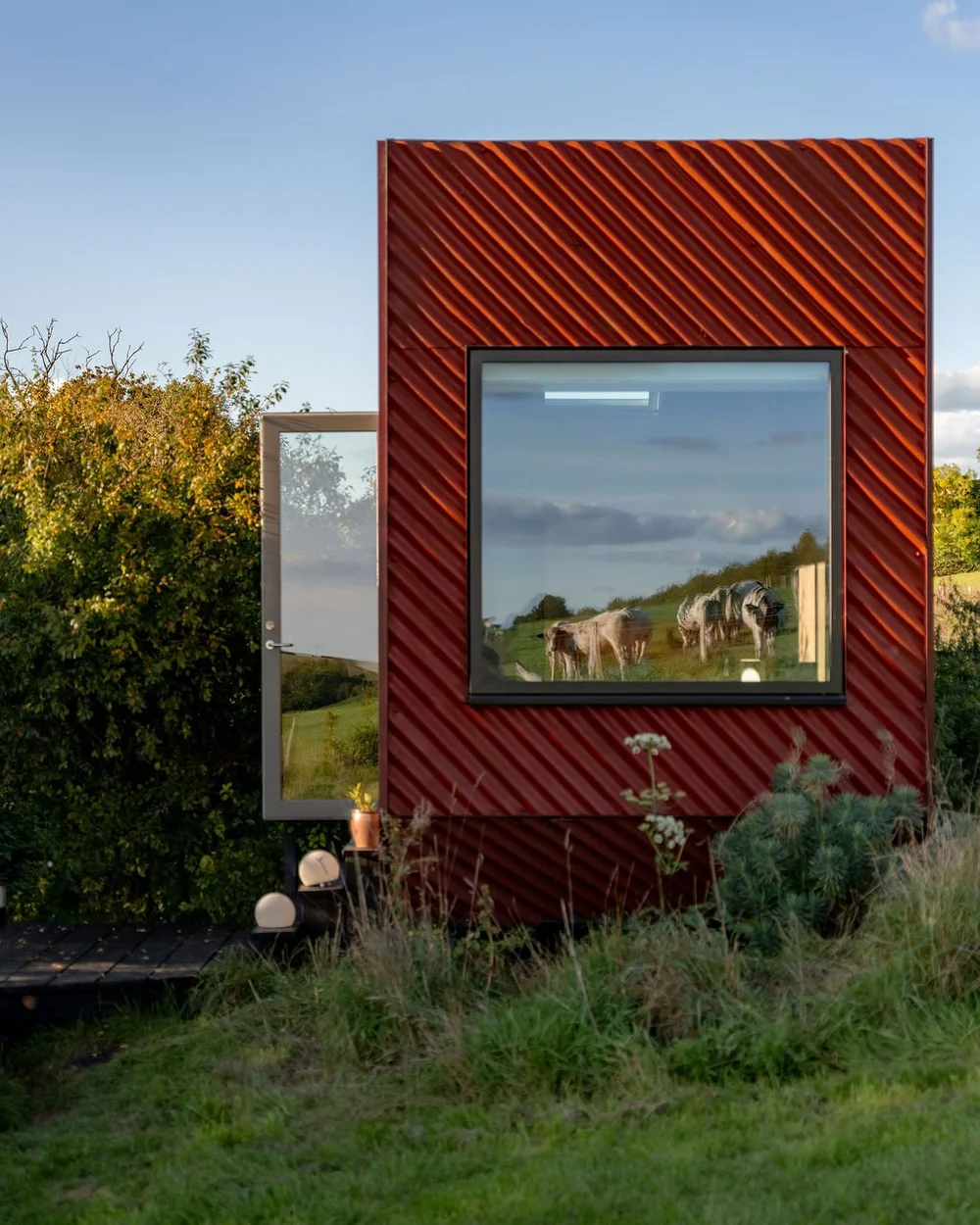 The Bothy — a contemporary red eco-cabin on a Dorset hillside at The Bide