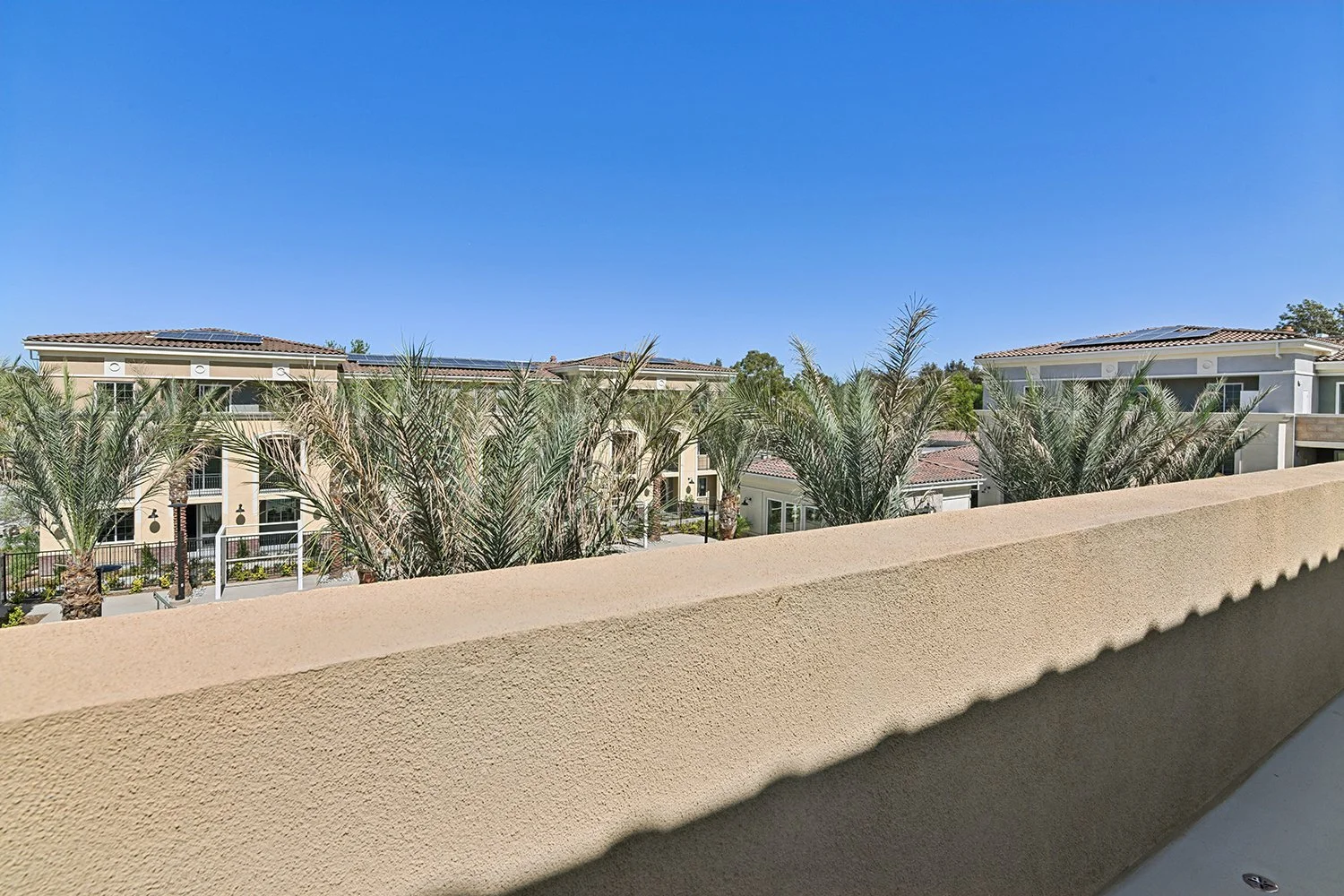 View from oversized private balcony attached to Rendezvous Phase II apartment home overlooking the Temecula Mountains and Rendezvous resort-style pool area. 