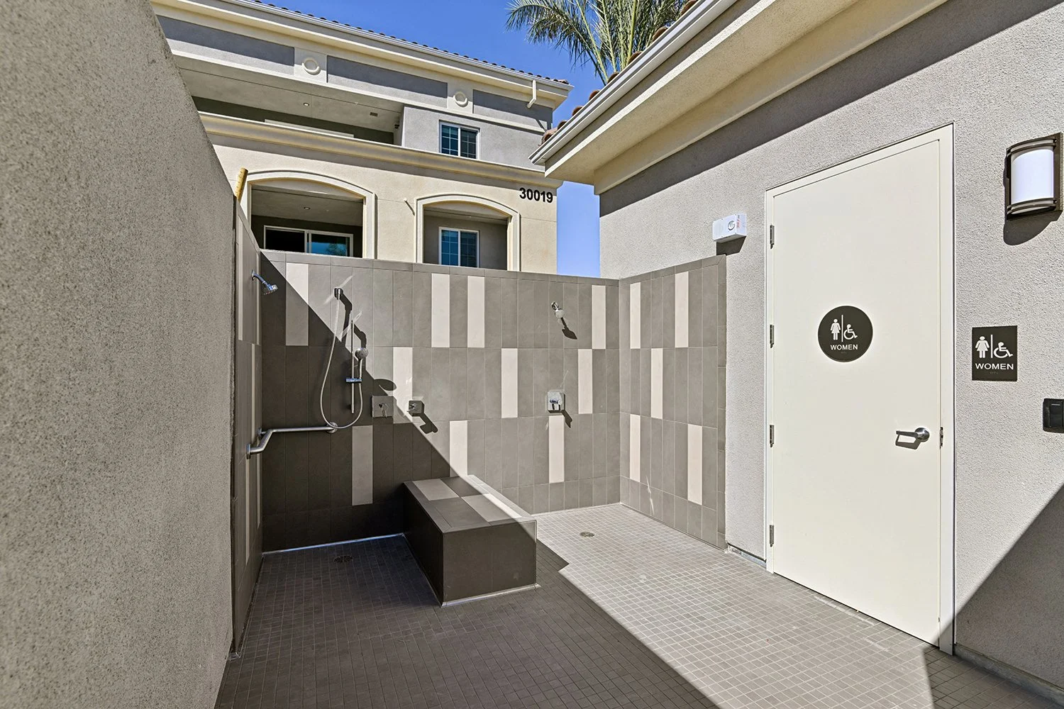 Luxurious outdoor shower at the Rendezvous Phase II pool area next to the pool area restroom. 