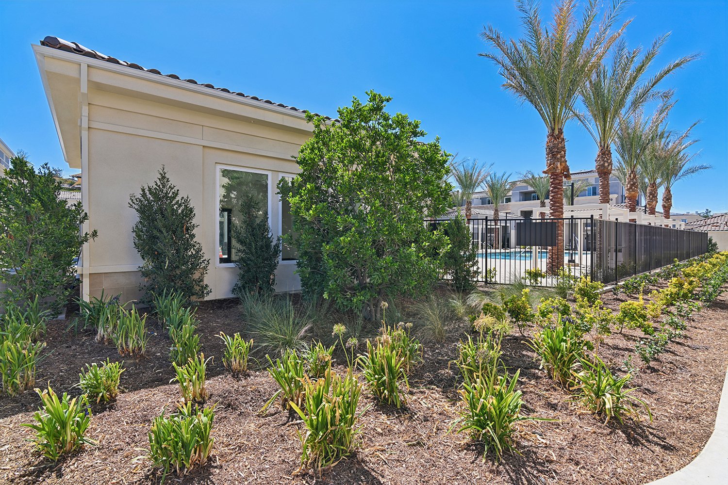 Lush landscaping outside fitness center and pool area at Rendezvous Phase II 