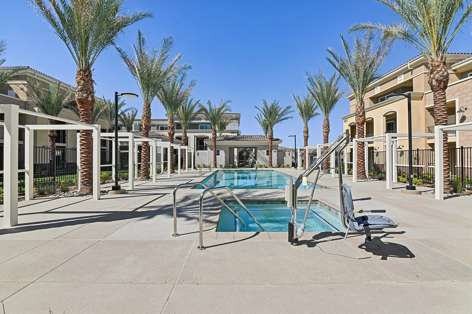 Rendezvous Phase II pool area lined with regal palm trees and cabanas, and with a relaxing spa. 