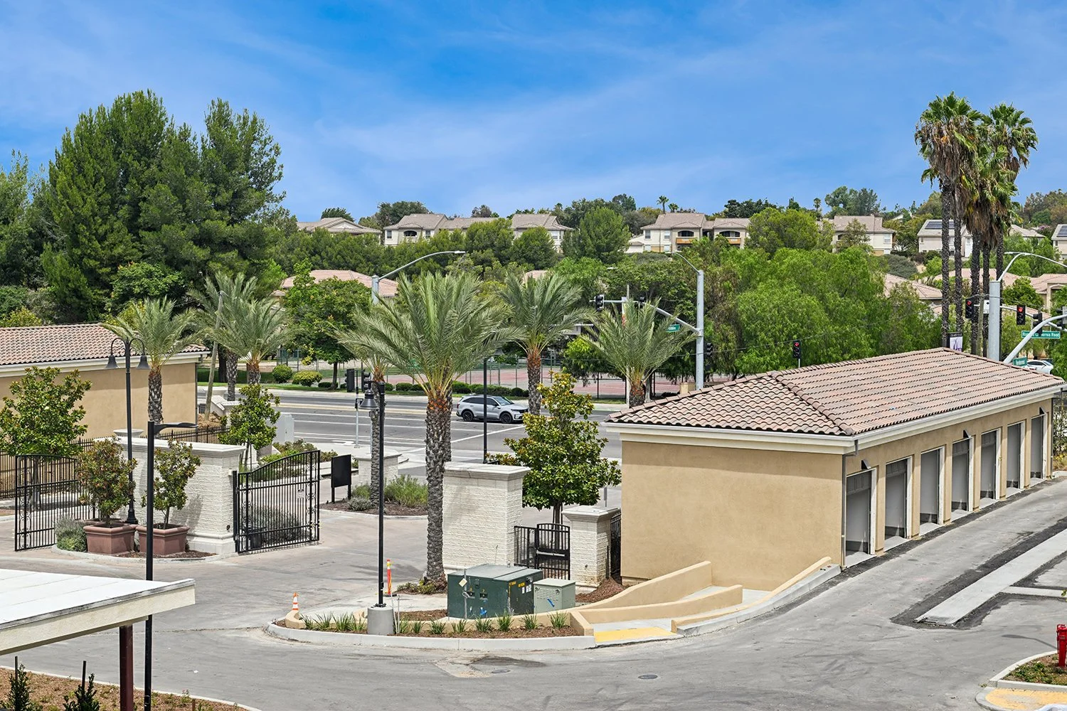View of grand gated entrance at Rendezvous Phase II surrounded by lush greenery