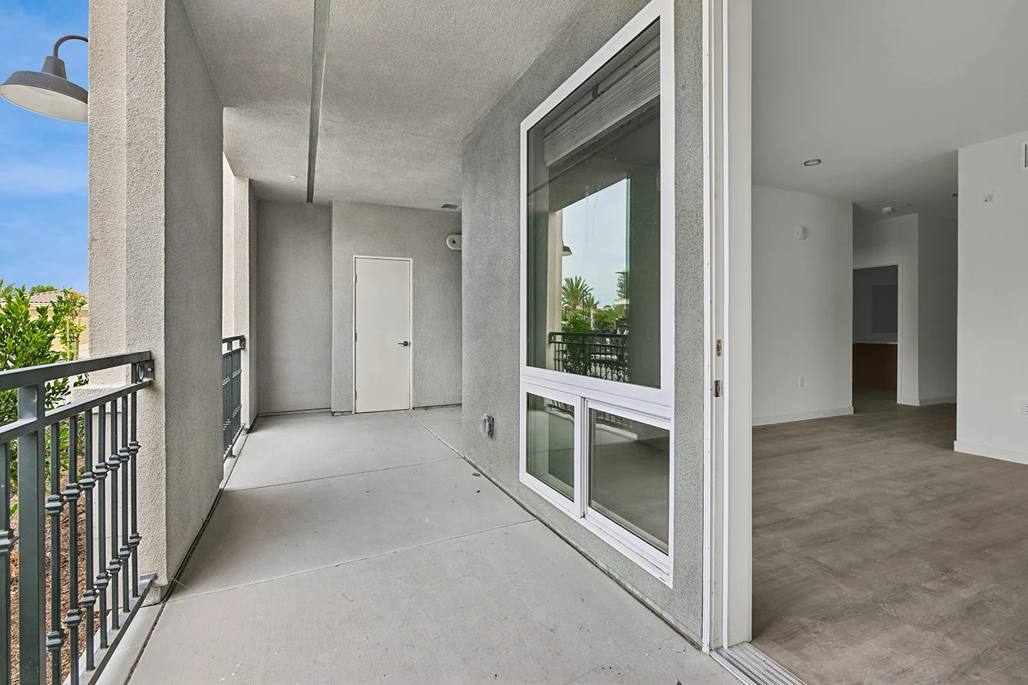 Oversized private patio in Rendezvous Phase II apartment home with gorgeous views and plenty of room for both a large outdoor dining set and a lounge seating area. 