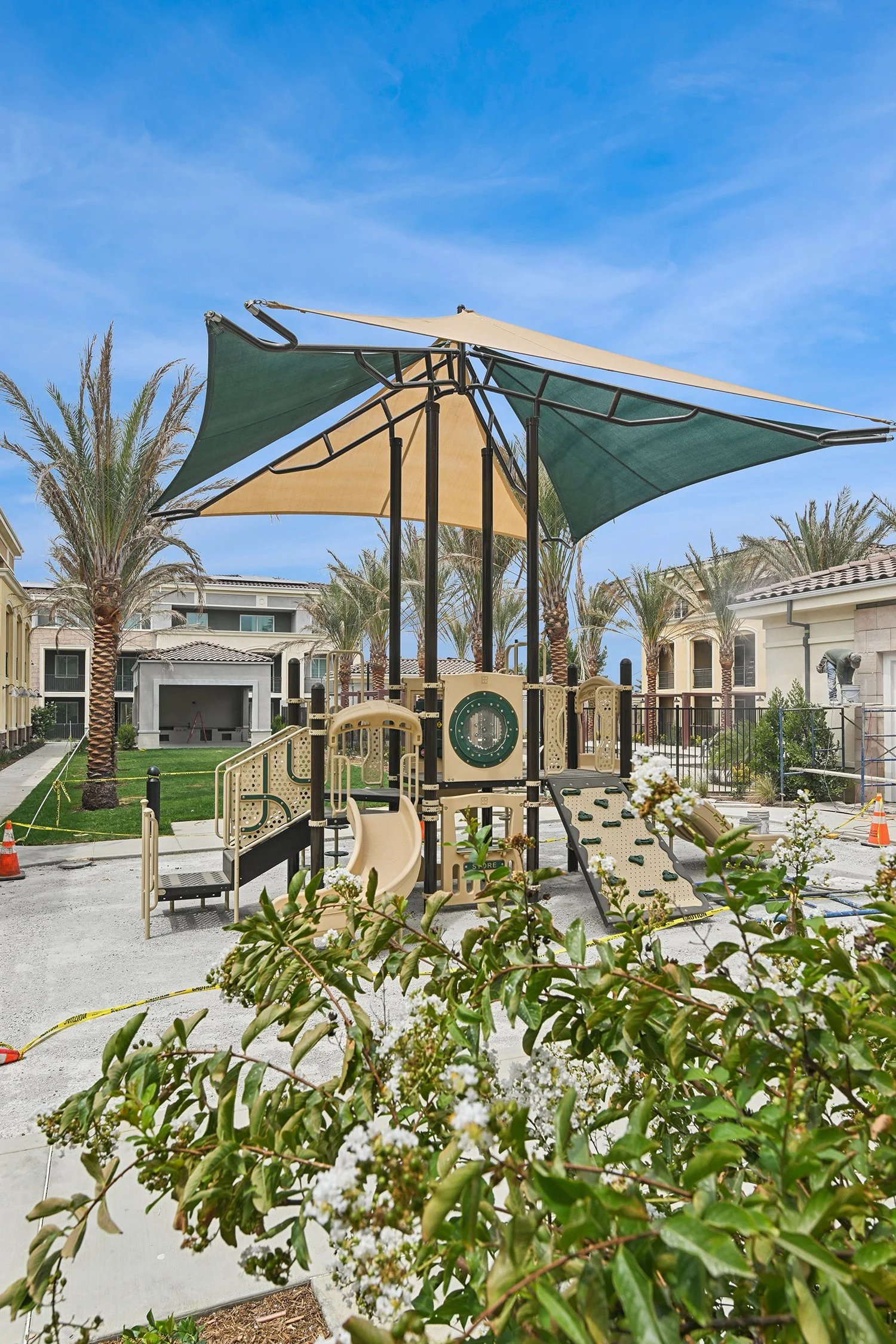 Play park at Rendezvous Phase II with large structure and modern and streamlined overhead shade sail for comfort and convenience. 