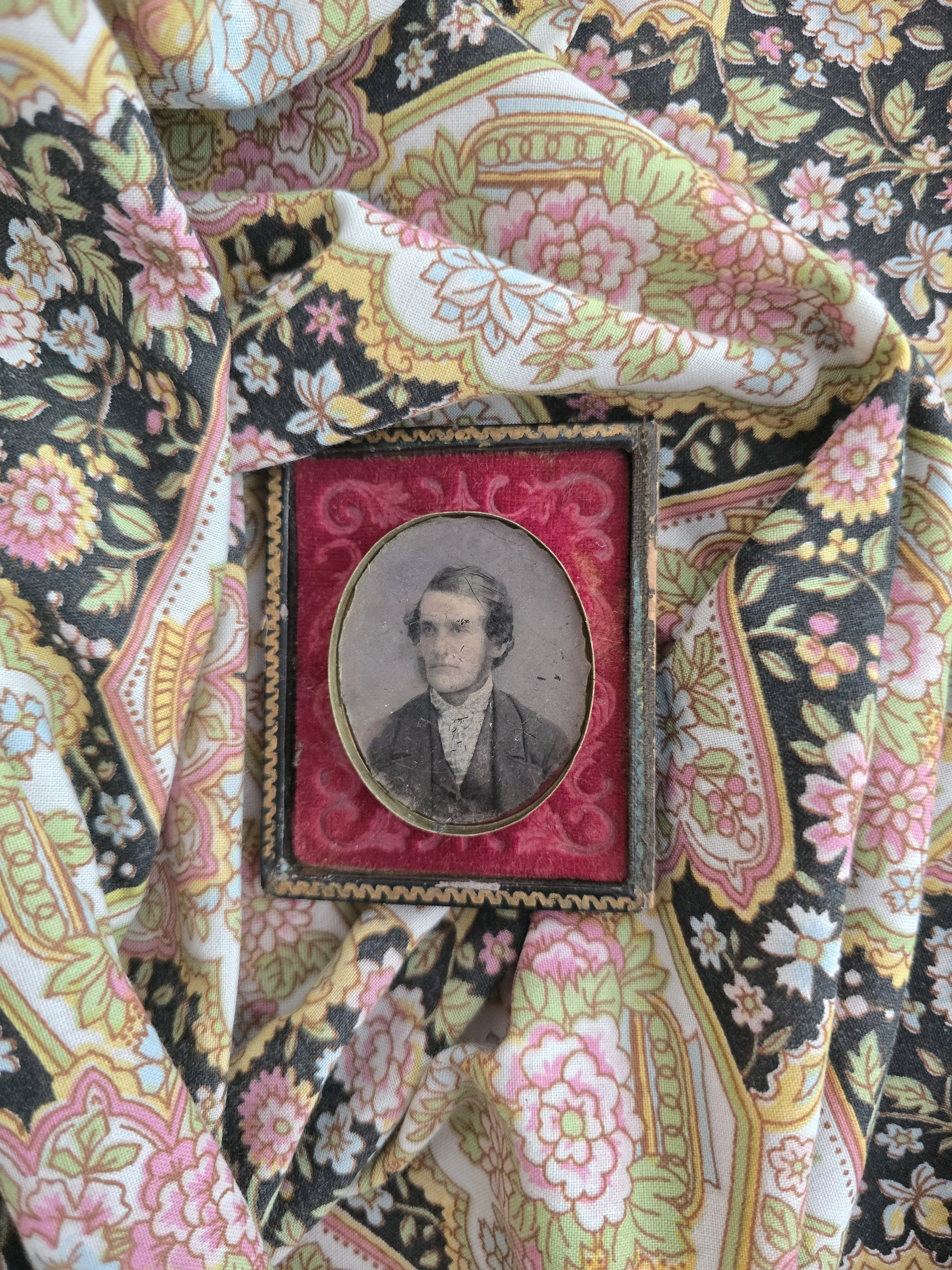 Victorian tintype portrait of a gentleman with original oval brass mat.