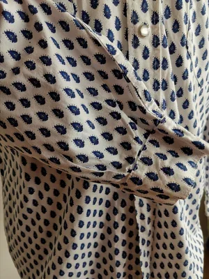 Button front detail of Provençale shirt with classic design.