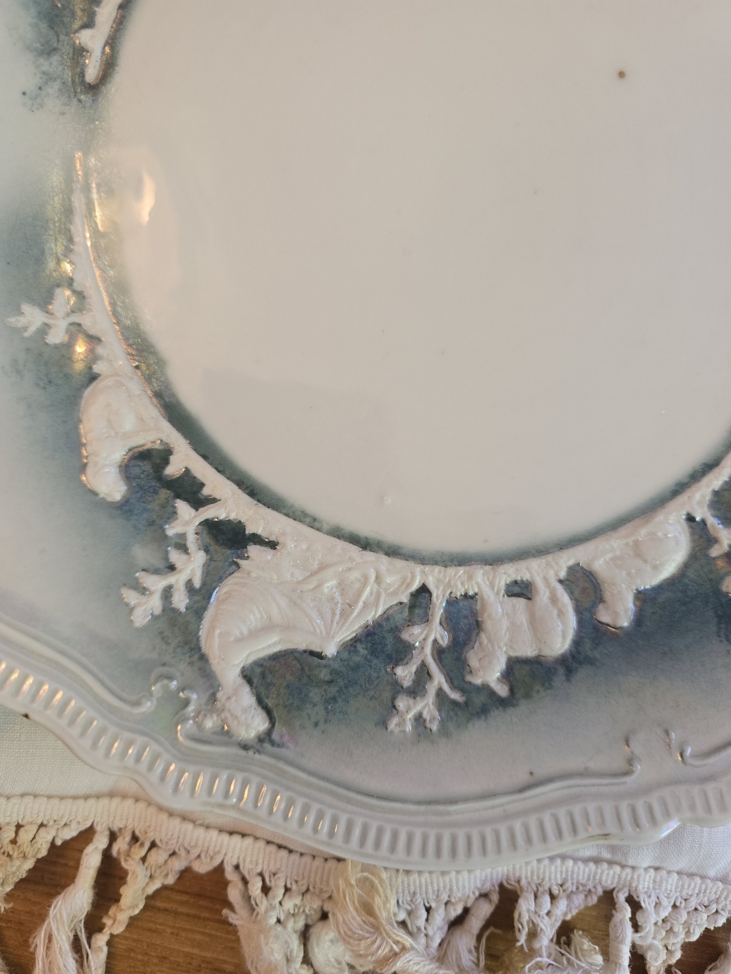 Detail of raised pastoral figures and foliage on vintage