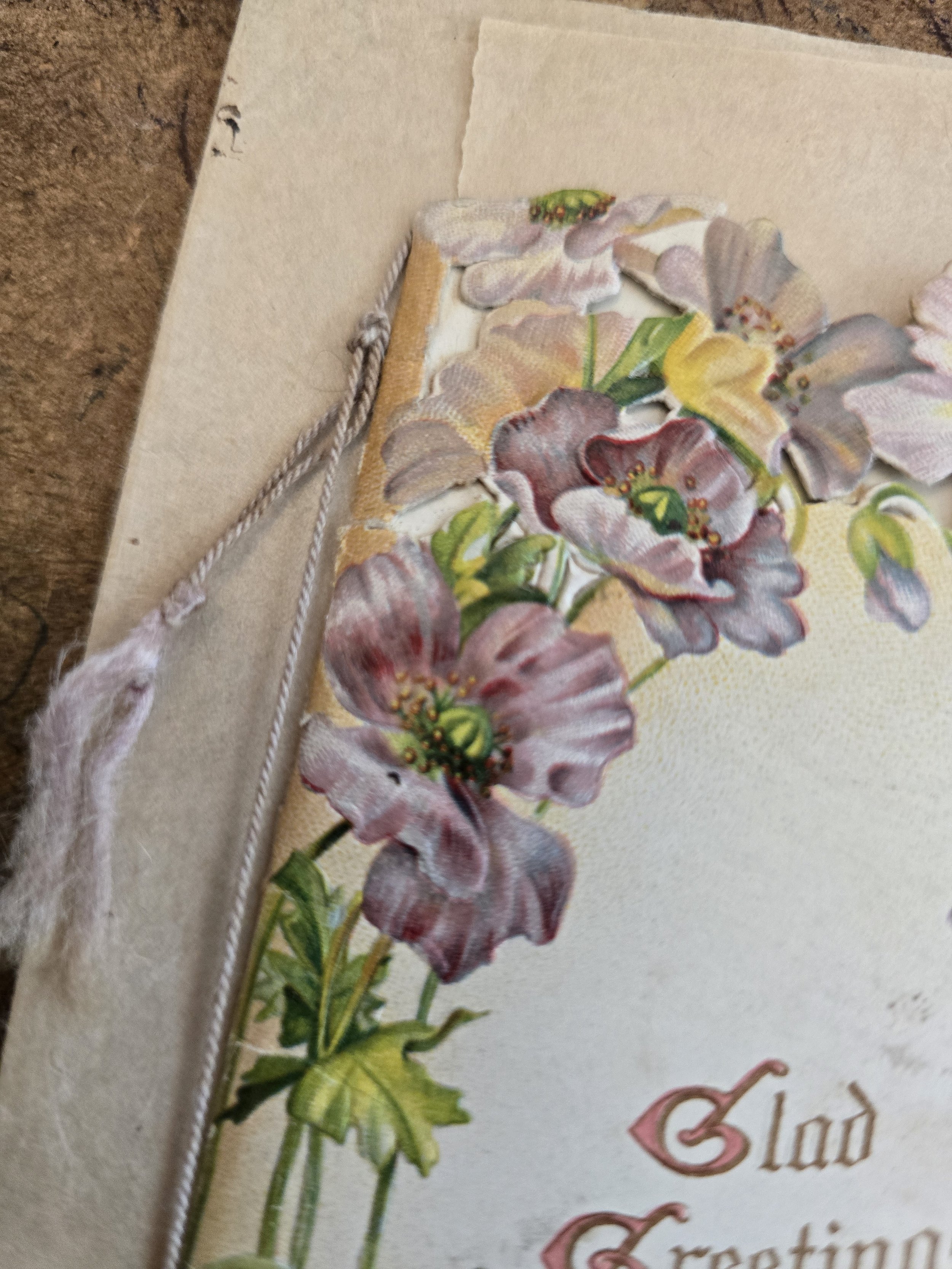 Close-up of embossed floral decoration on antique Victorian Christmas card