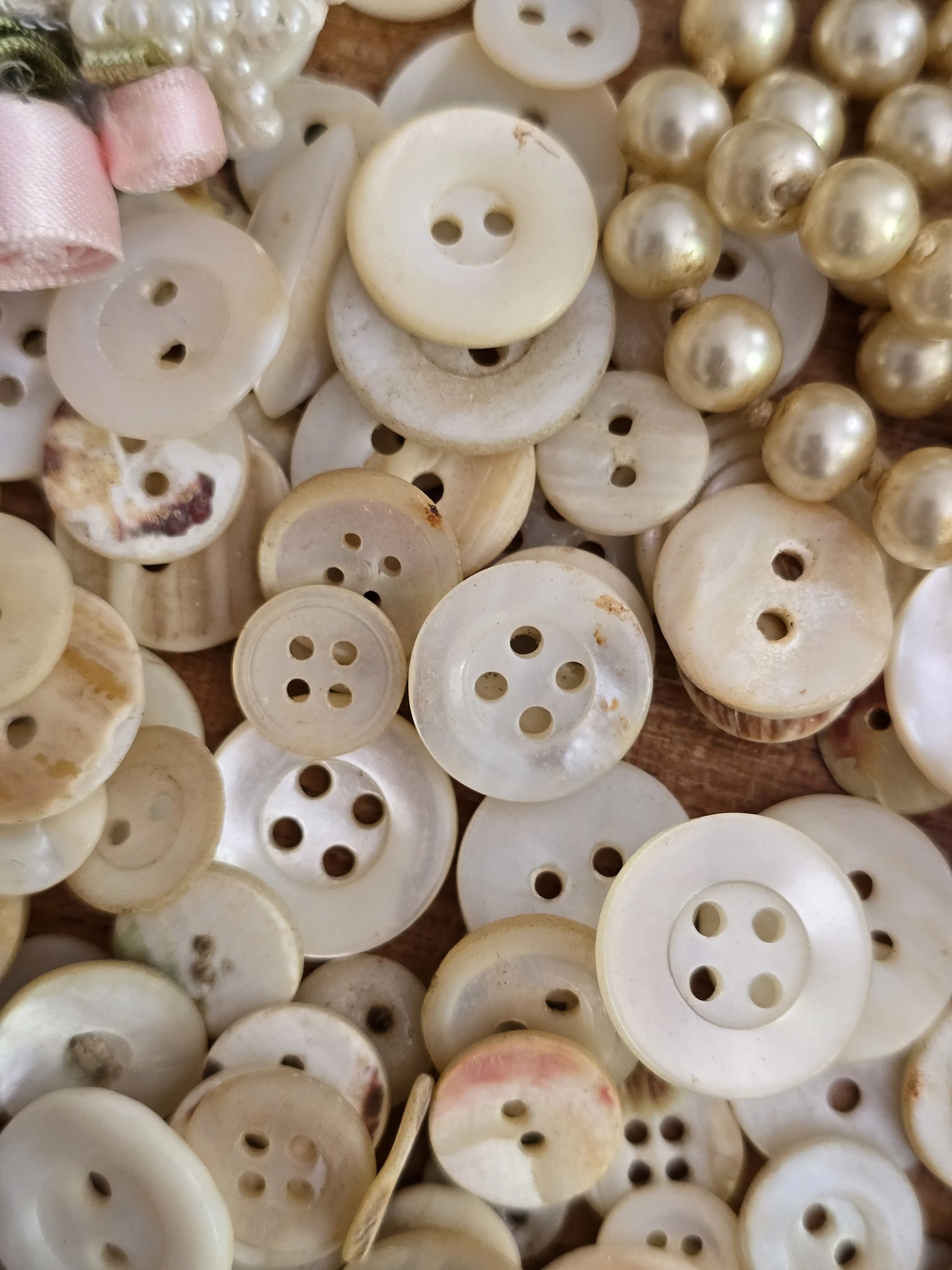 Mixed vintage shell buttons for sewing, restoration and textile art, featuring a variety of sizes and finishes.