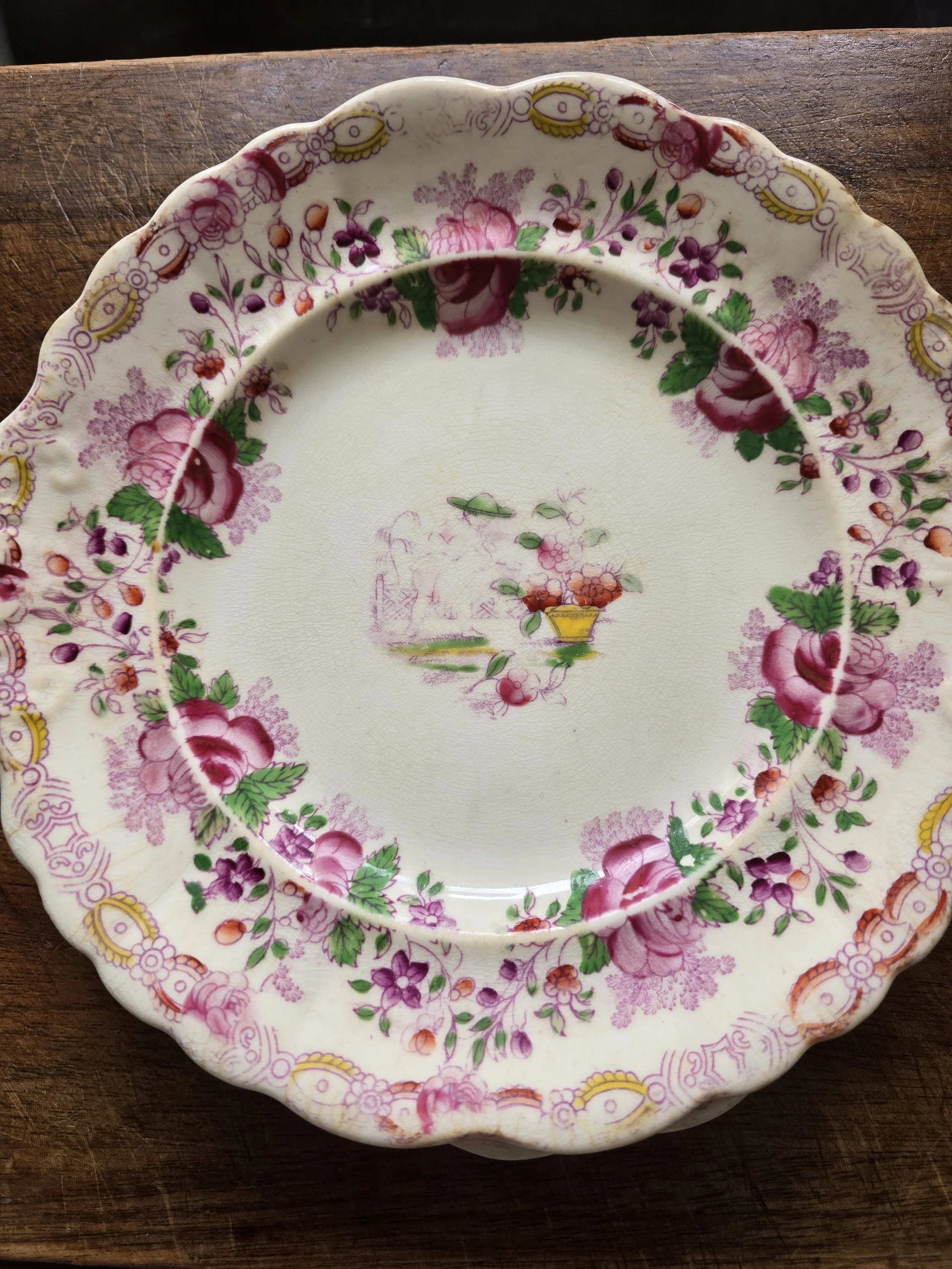 Antique Staffordshire ceramic plate featuring hand-coloured floral decoration.