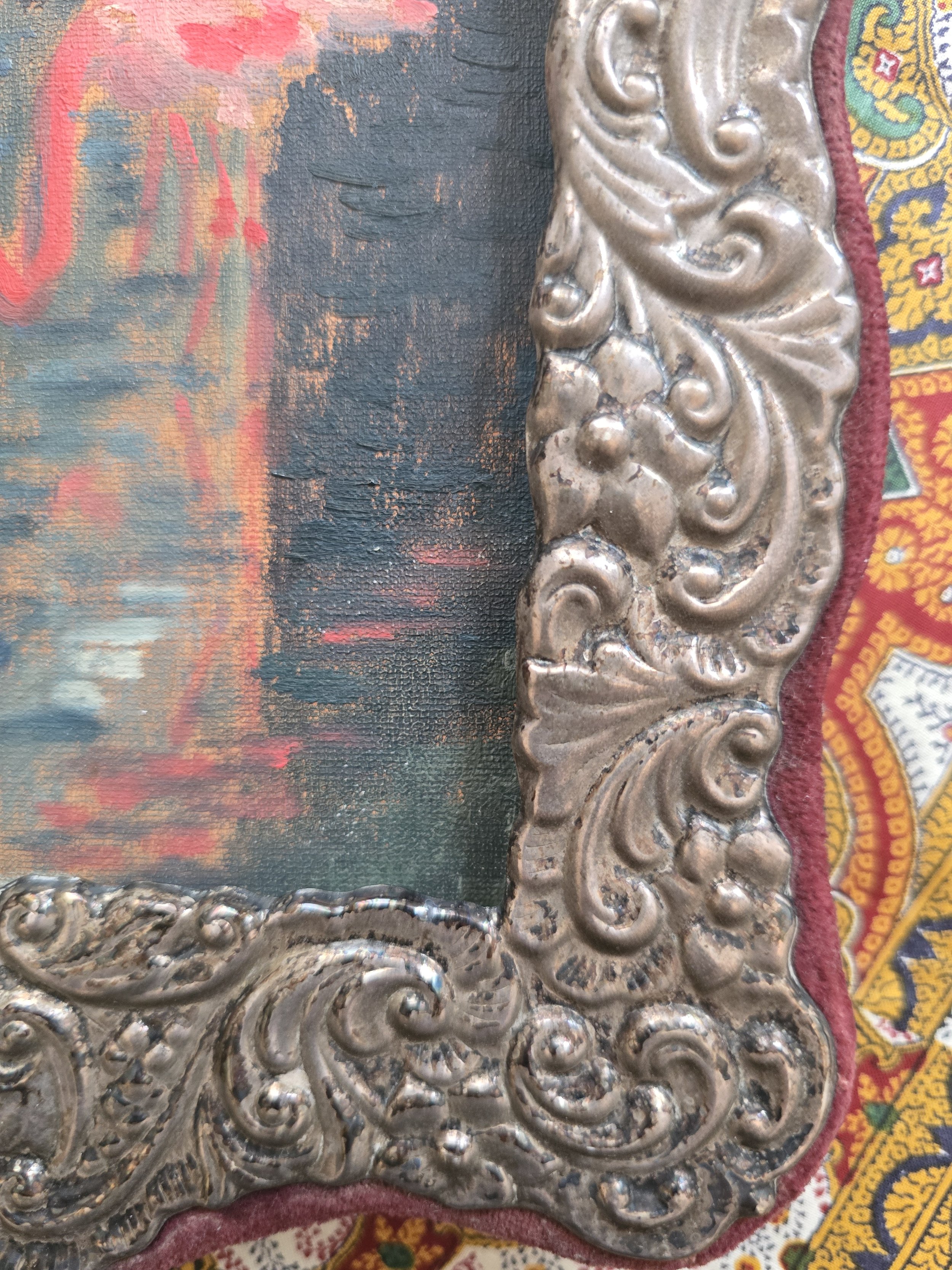 Antique Victorian easel frame featuring embossed Rococo-inspired silvered metal decoration.