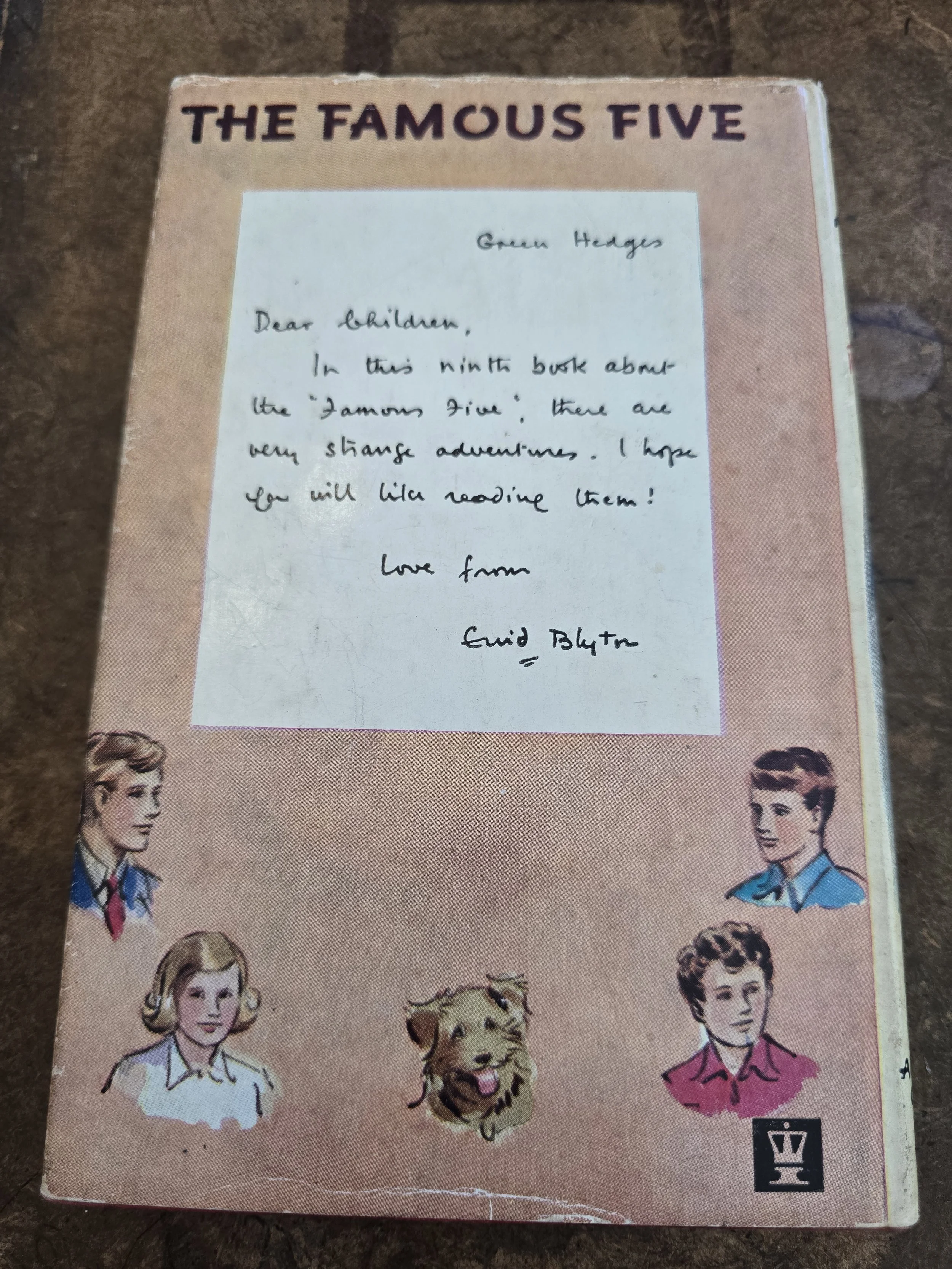 Illustrated dust jacket showing a Famous Five seaside adventure scene with Timmy the dog.