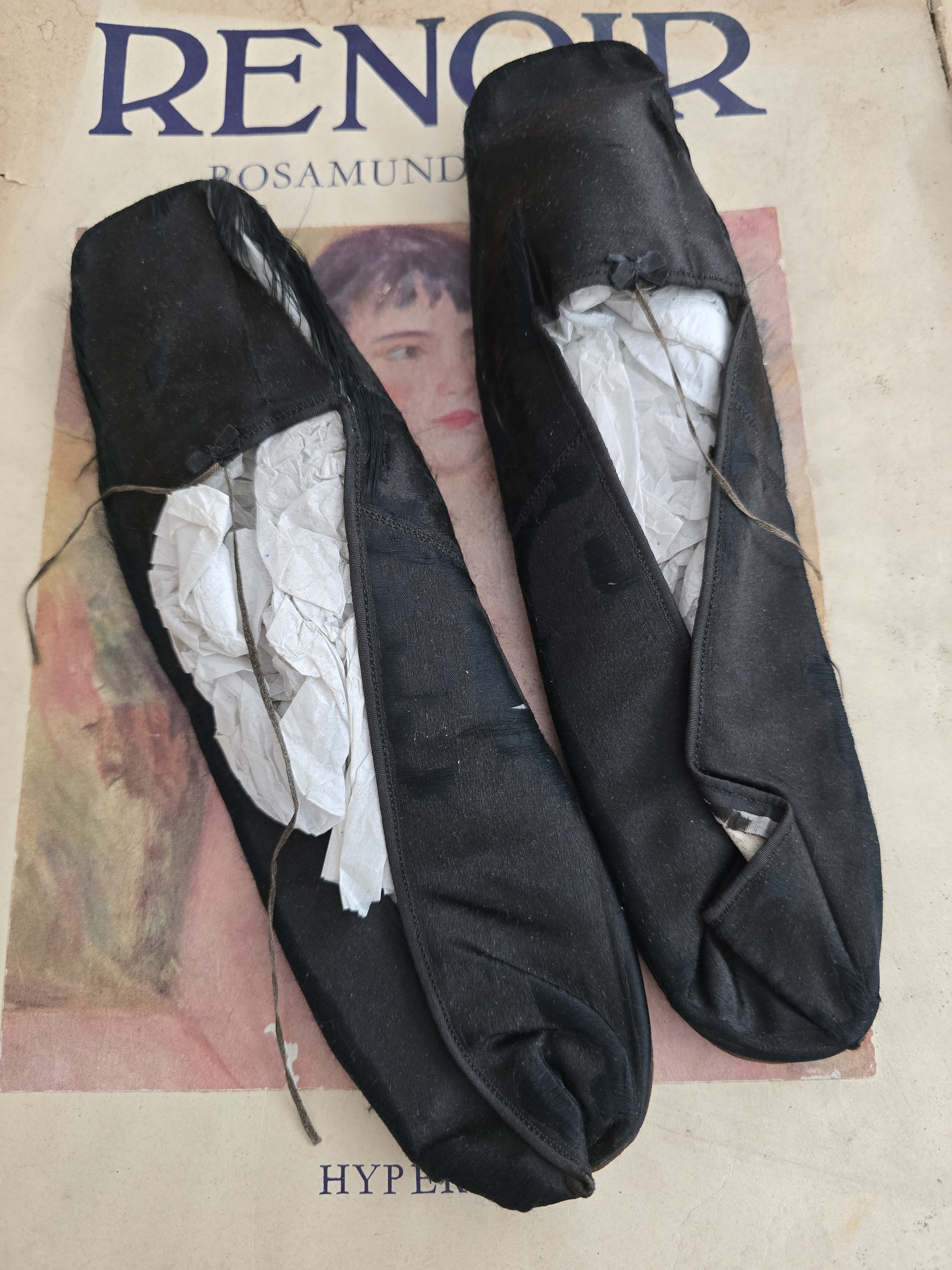 Pair of antique black silk satin French slippers with ribbon ties.