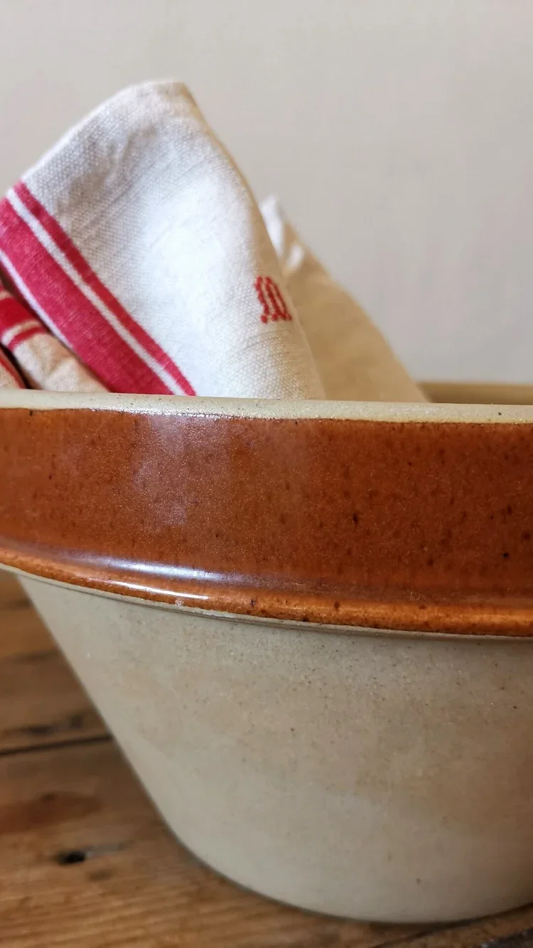 Full view of large vintage Digoin stoneware bowl on French linen cloth