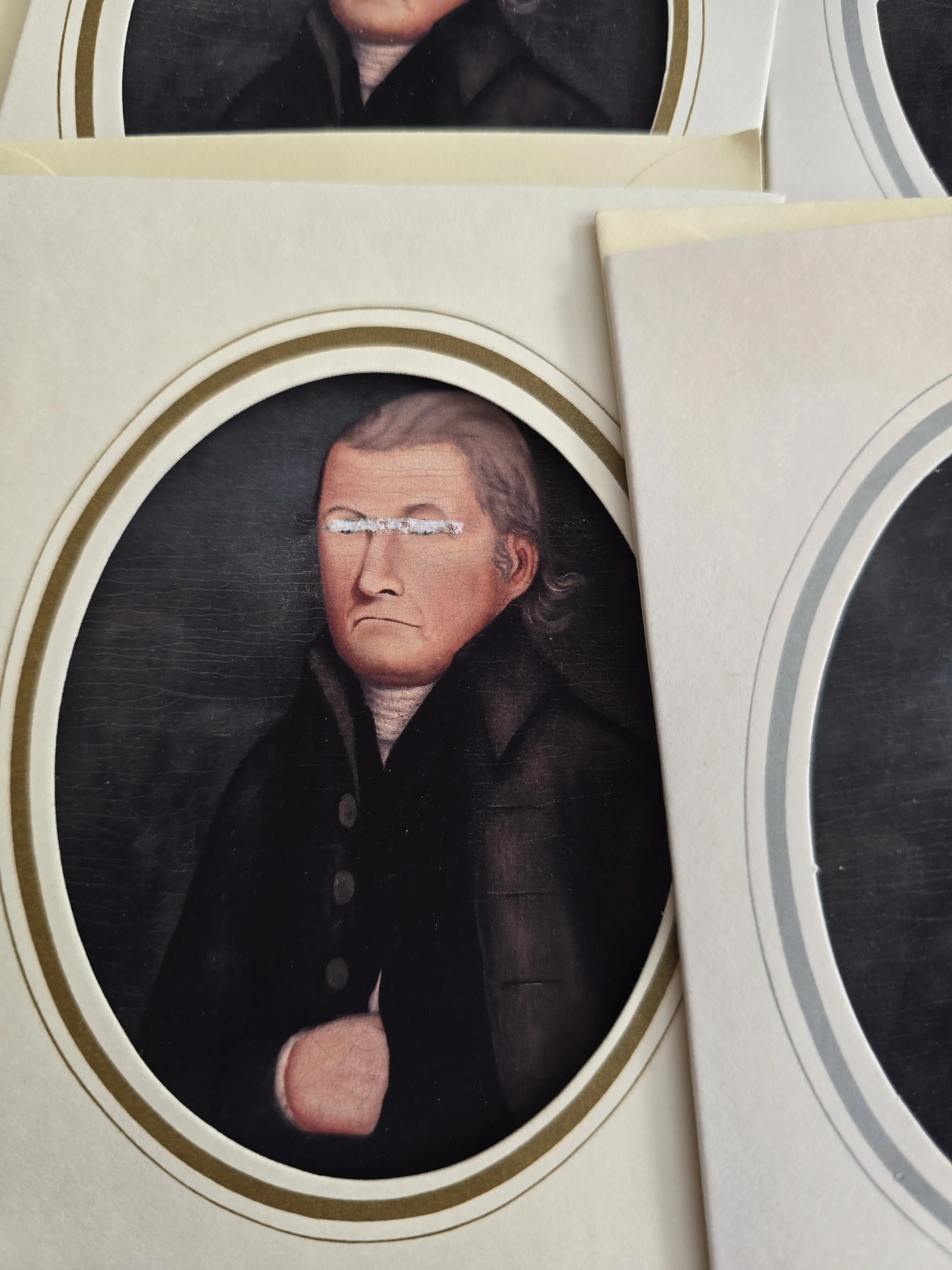 Handmade Halloween card with strange vintage portrait, obscured eyes and aged gold oval border.