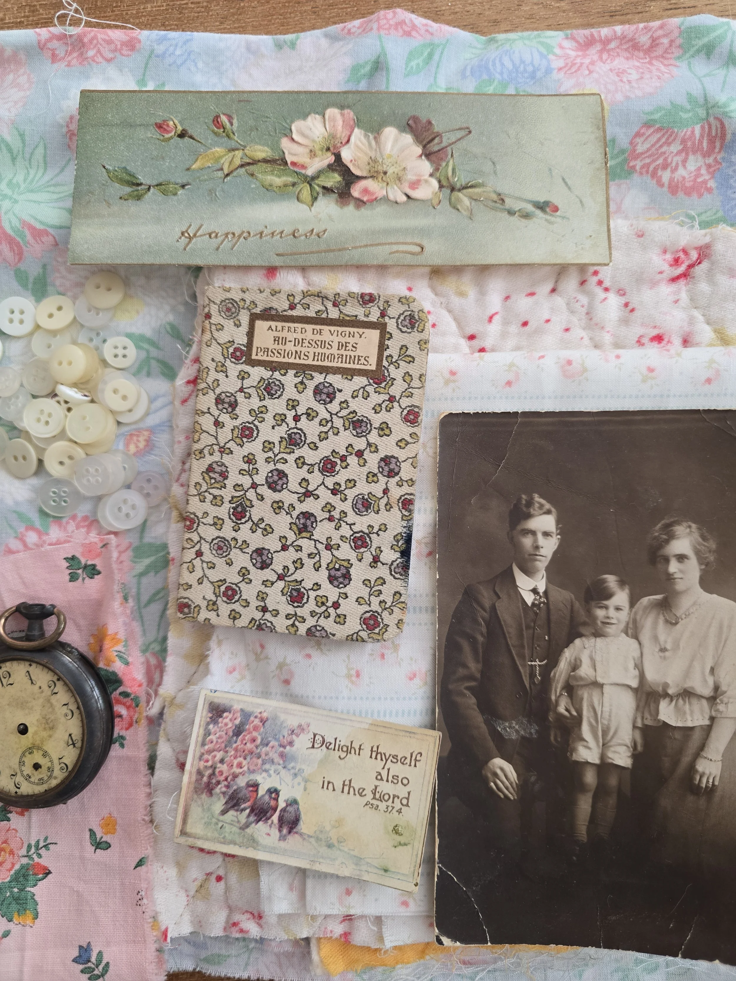 vintage assemblage with antique pocket watch fabric book and layered textiles