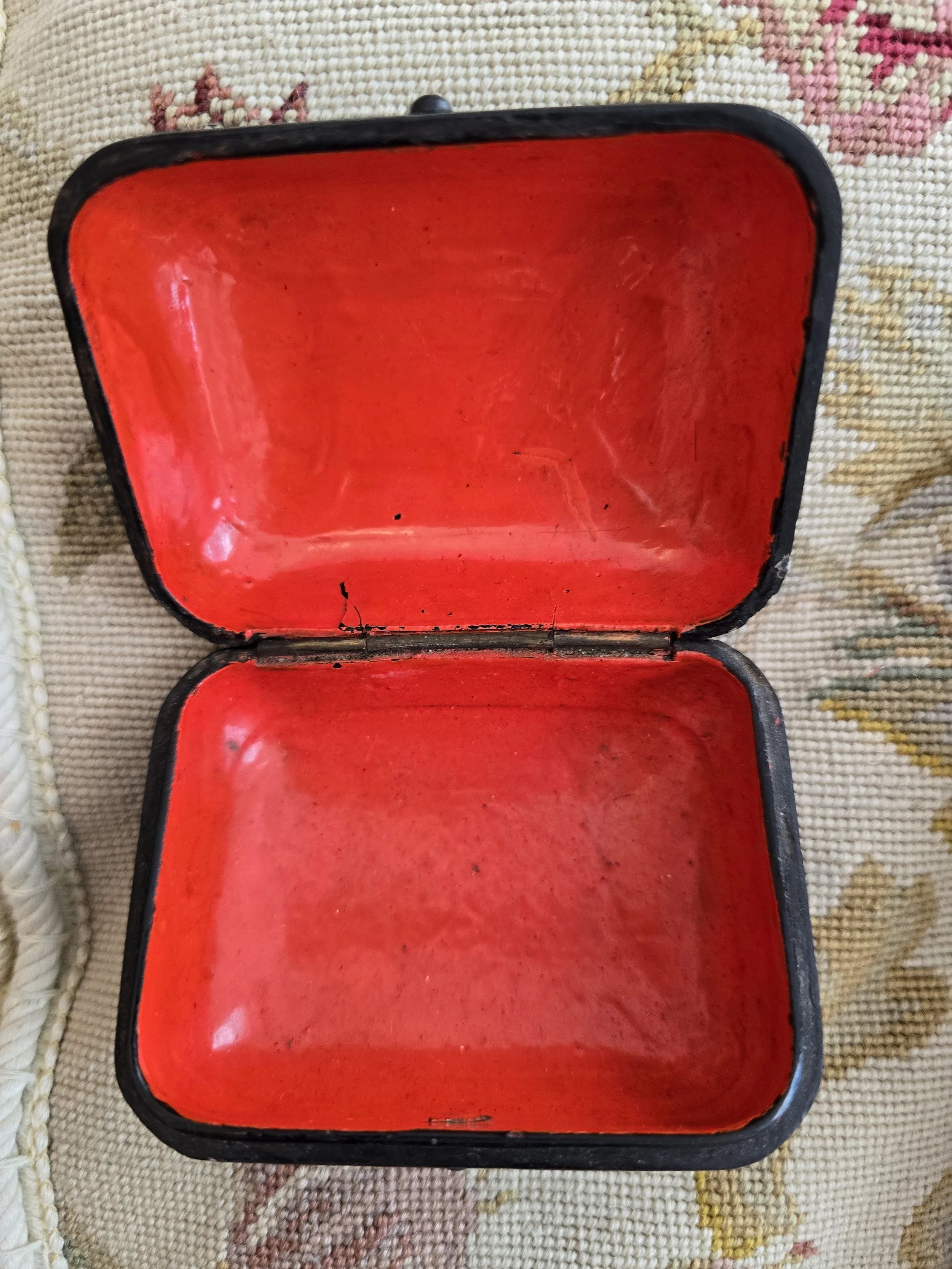 Vintage floral trinket box showing bright red lacquer-style interior