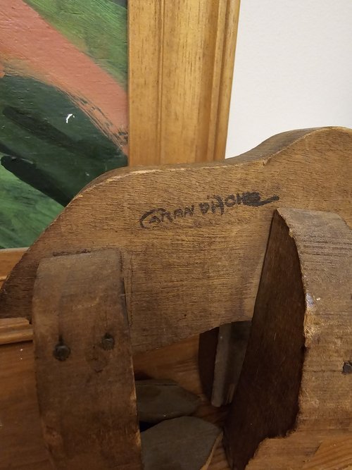 Close-up of signature on wooden toy bear attributed to Caran d’Ache