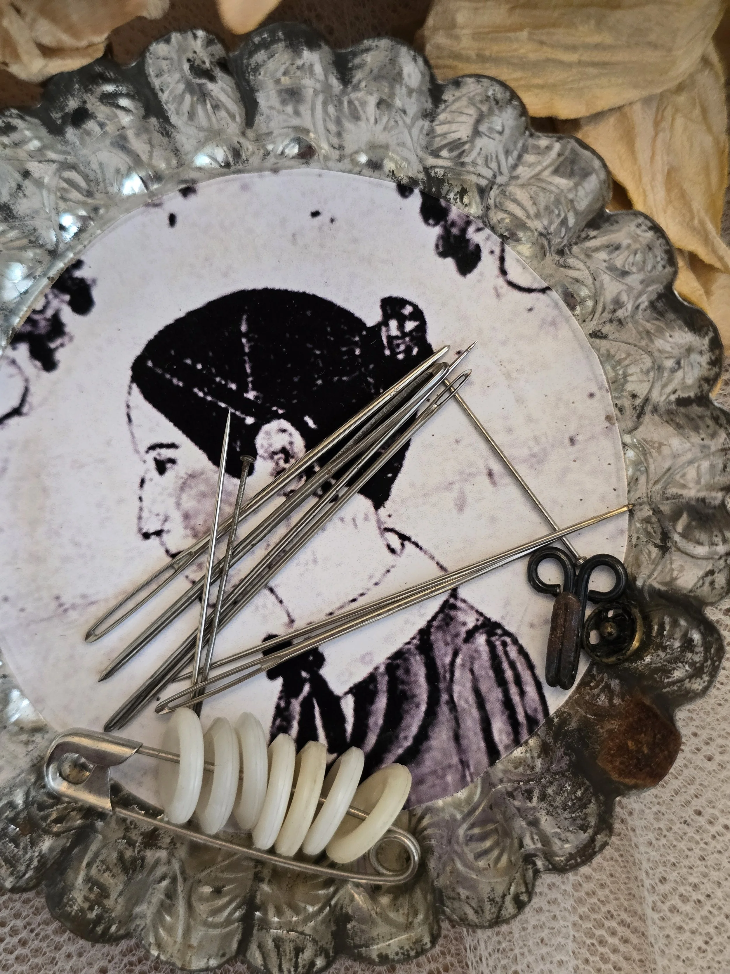 Early American folk art portrait inside enamel sewing accessory.