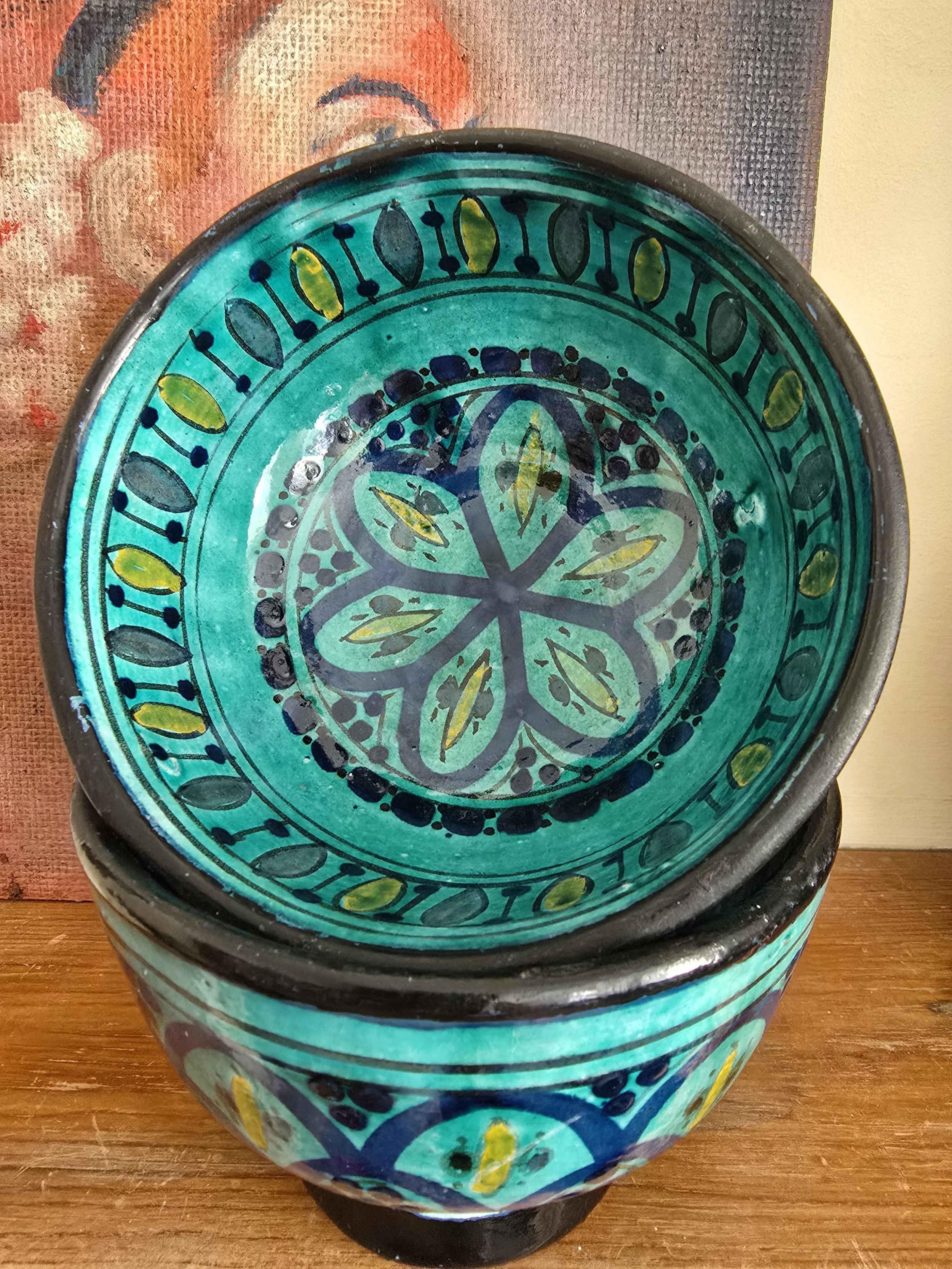 Overhead view of Zlafah bowl interior with floral medallion design in turquoise and yellow