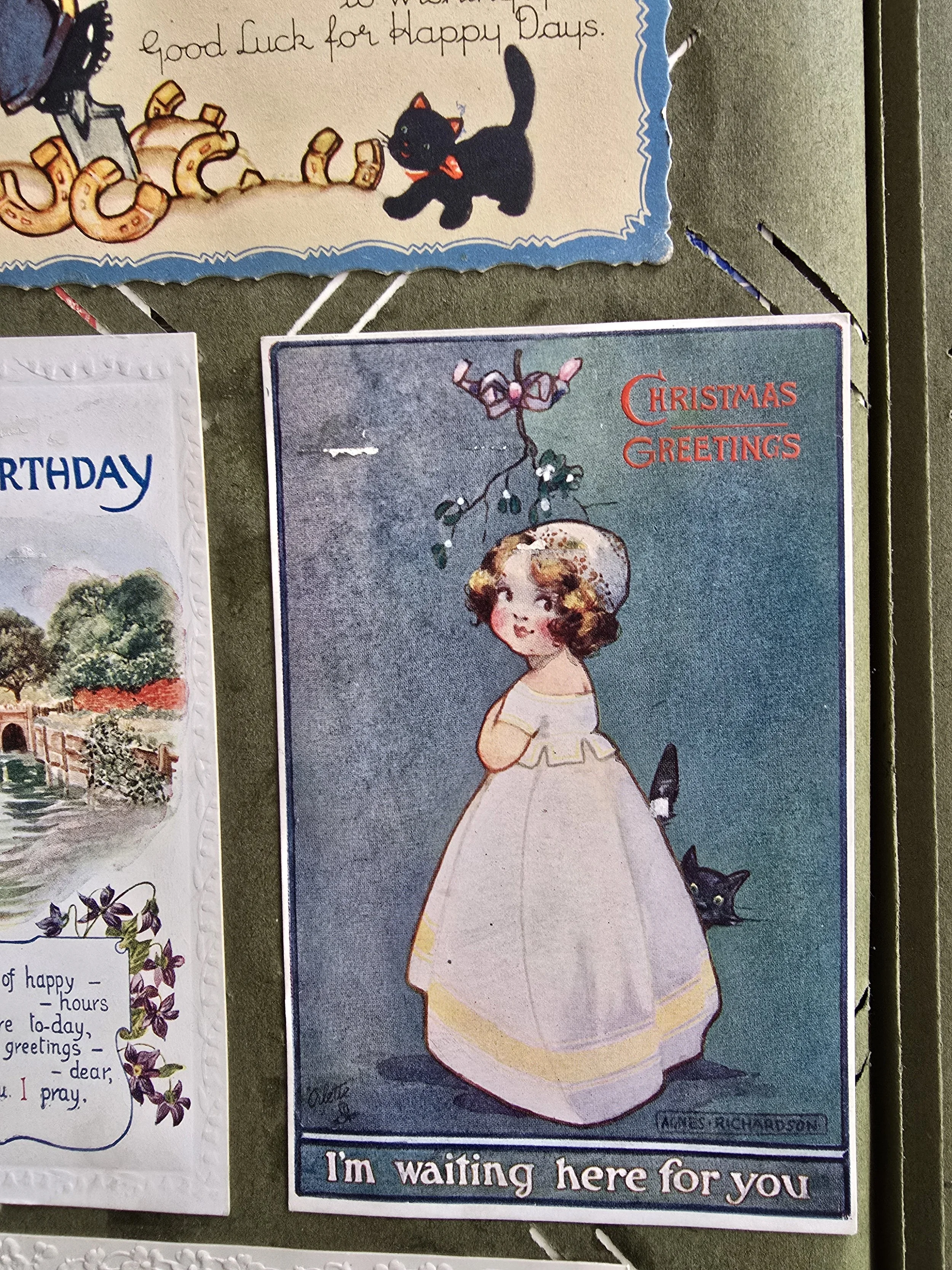 Ames Richardson illustrated Christmas card featuring young girl with cat under mistletoe